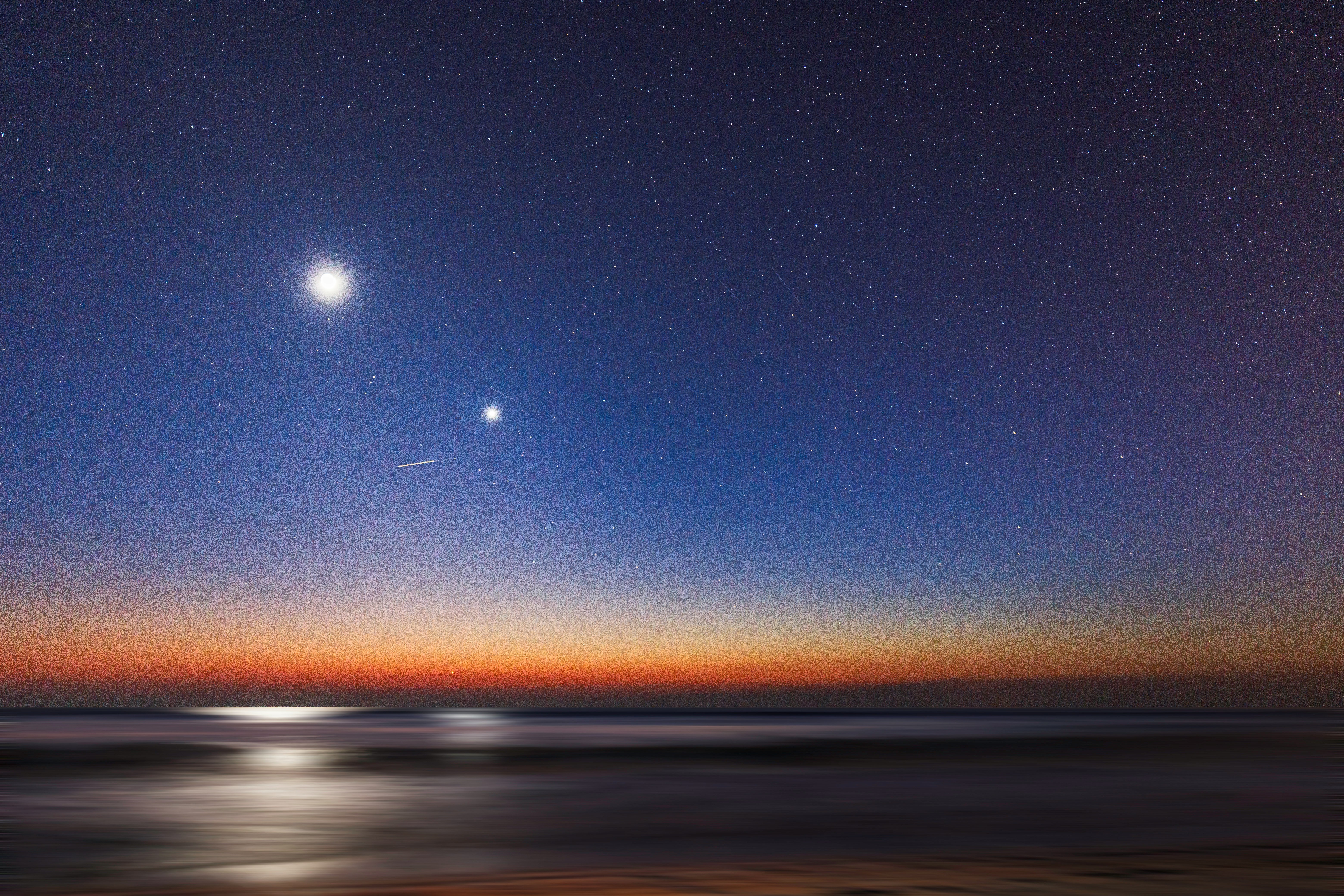 two stars above a beach at sunset