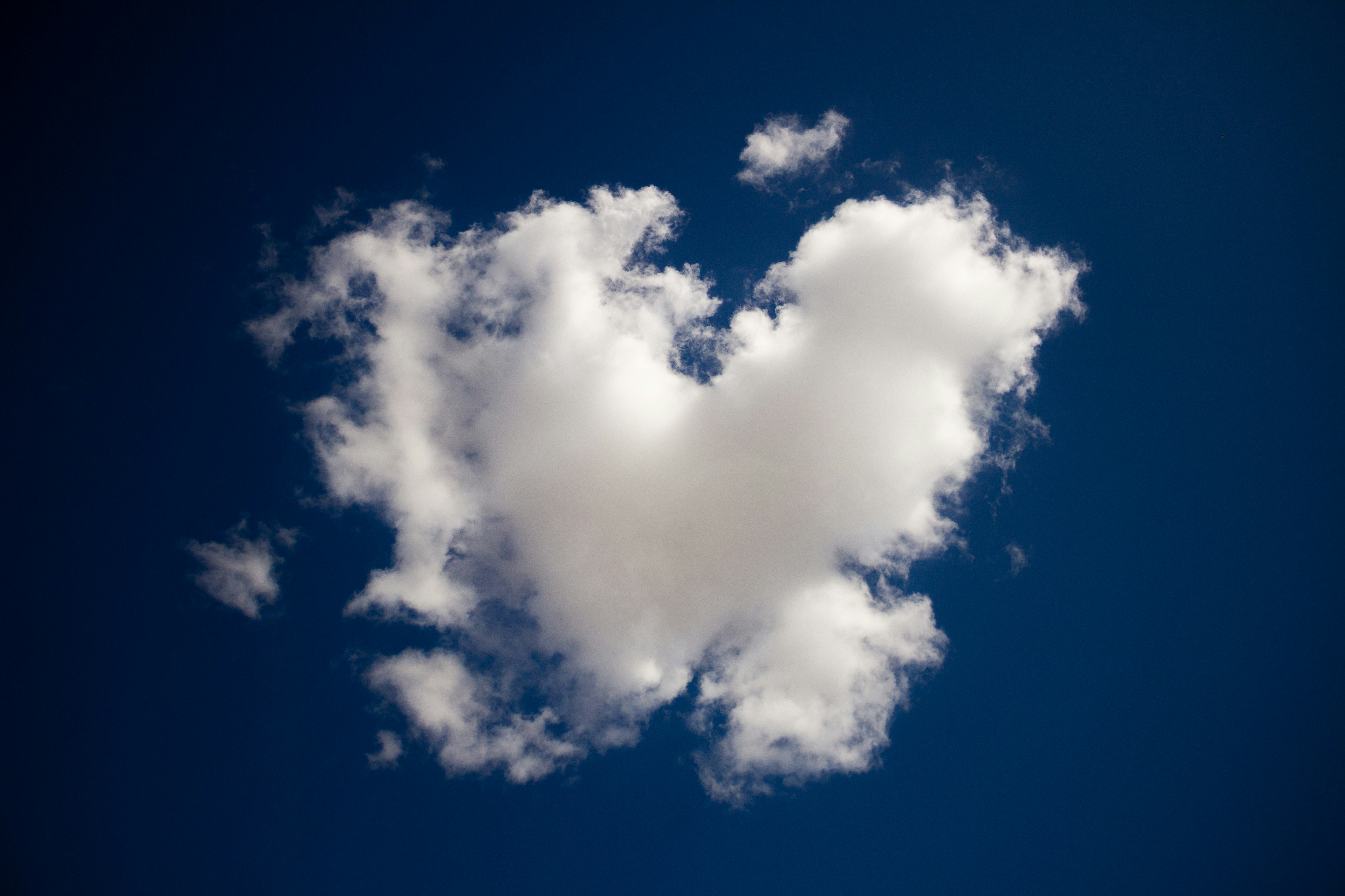 heart-shaped cloud in blue sky