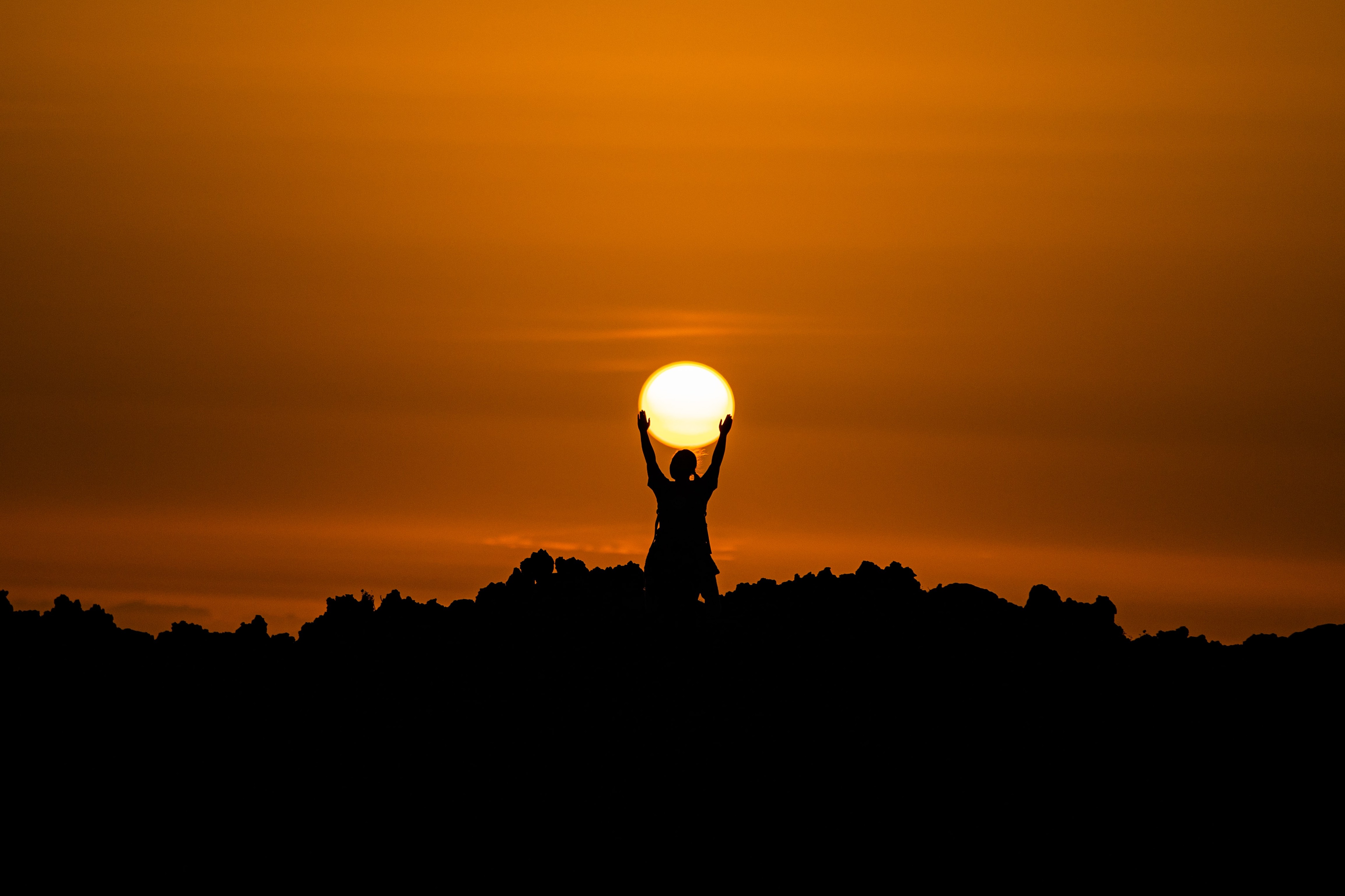person holding the sun