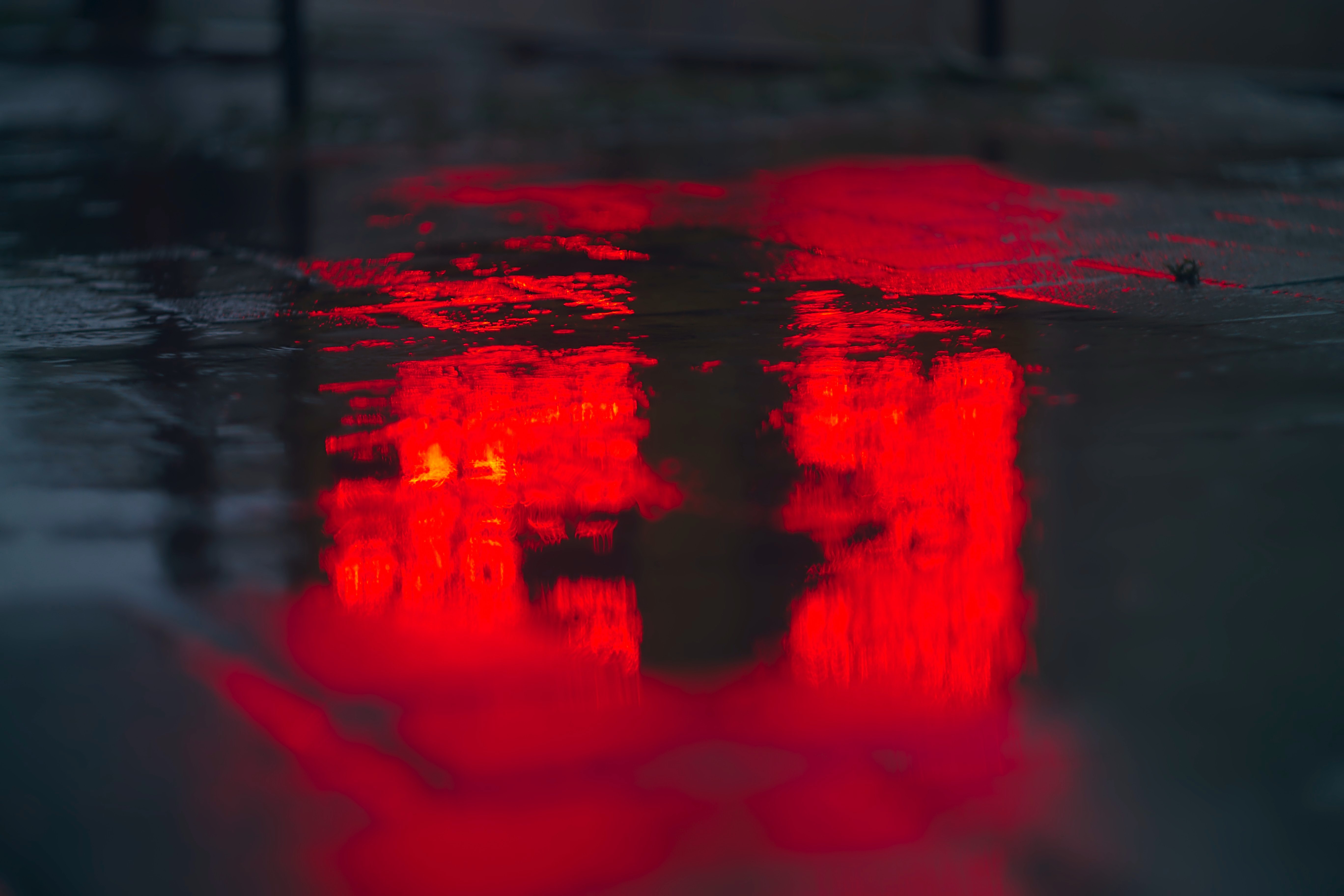 red street lights on a dark wet street