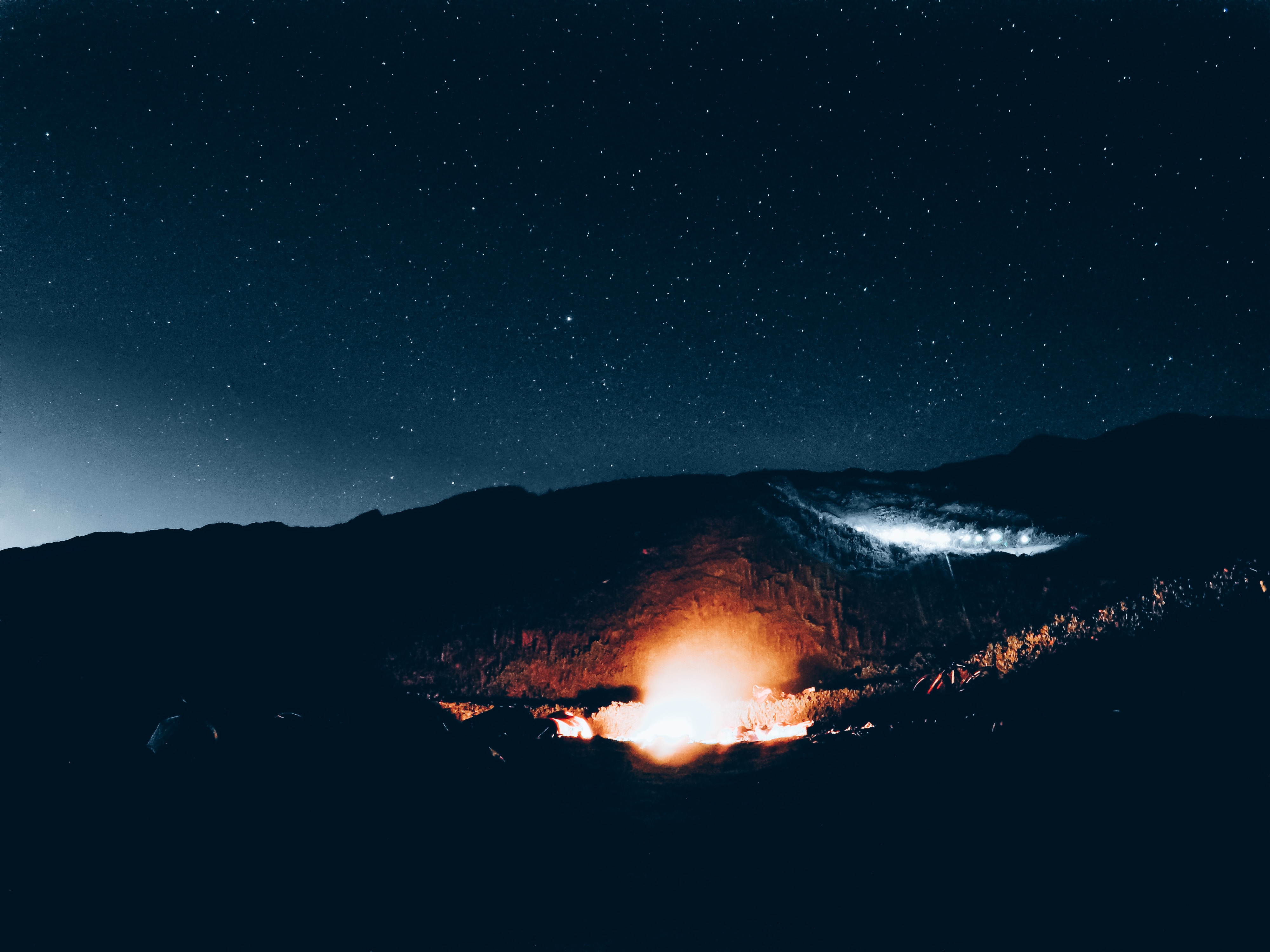 a fire burning beneath a night sky