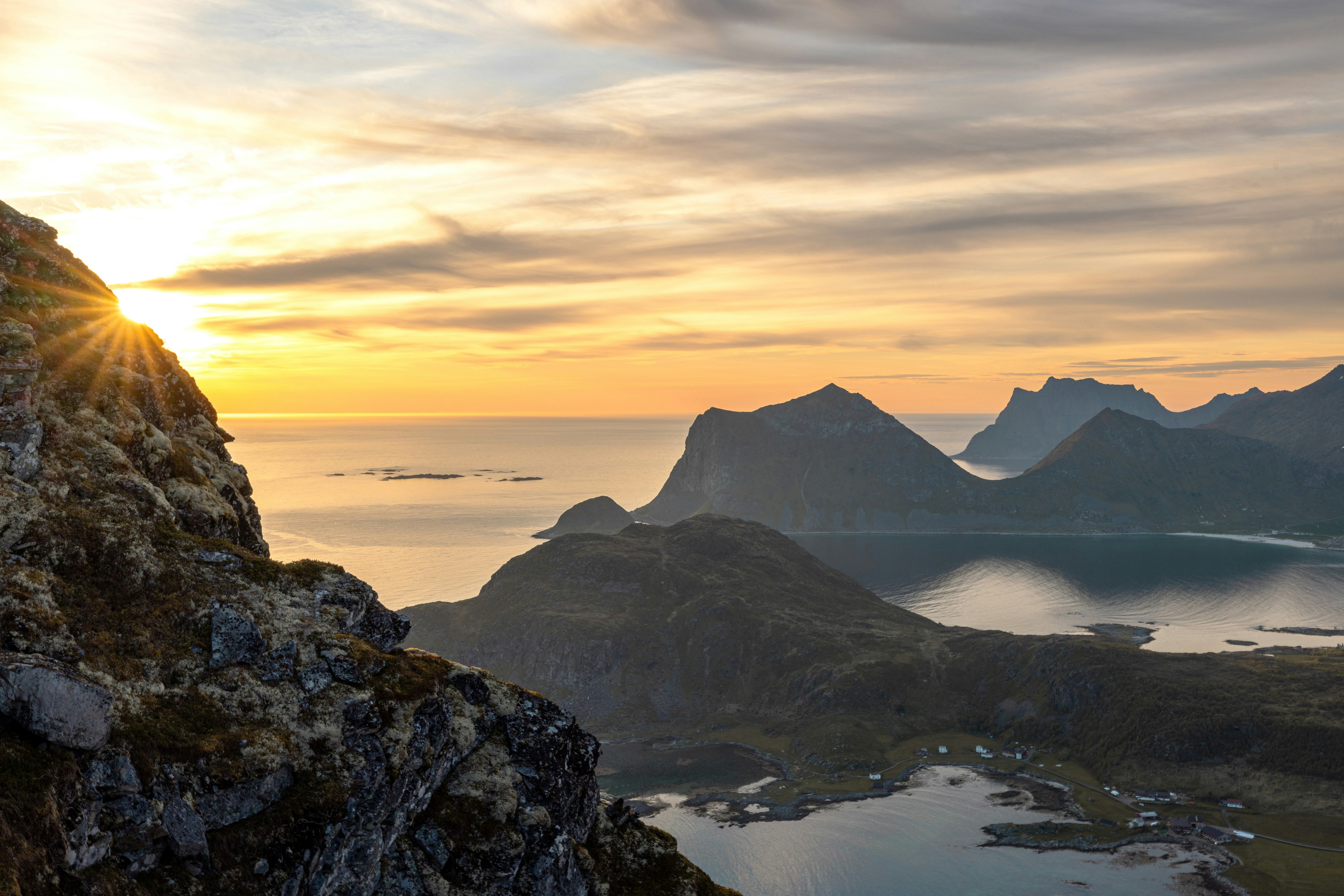 sun cresting over sharp rocky crags