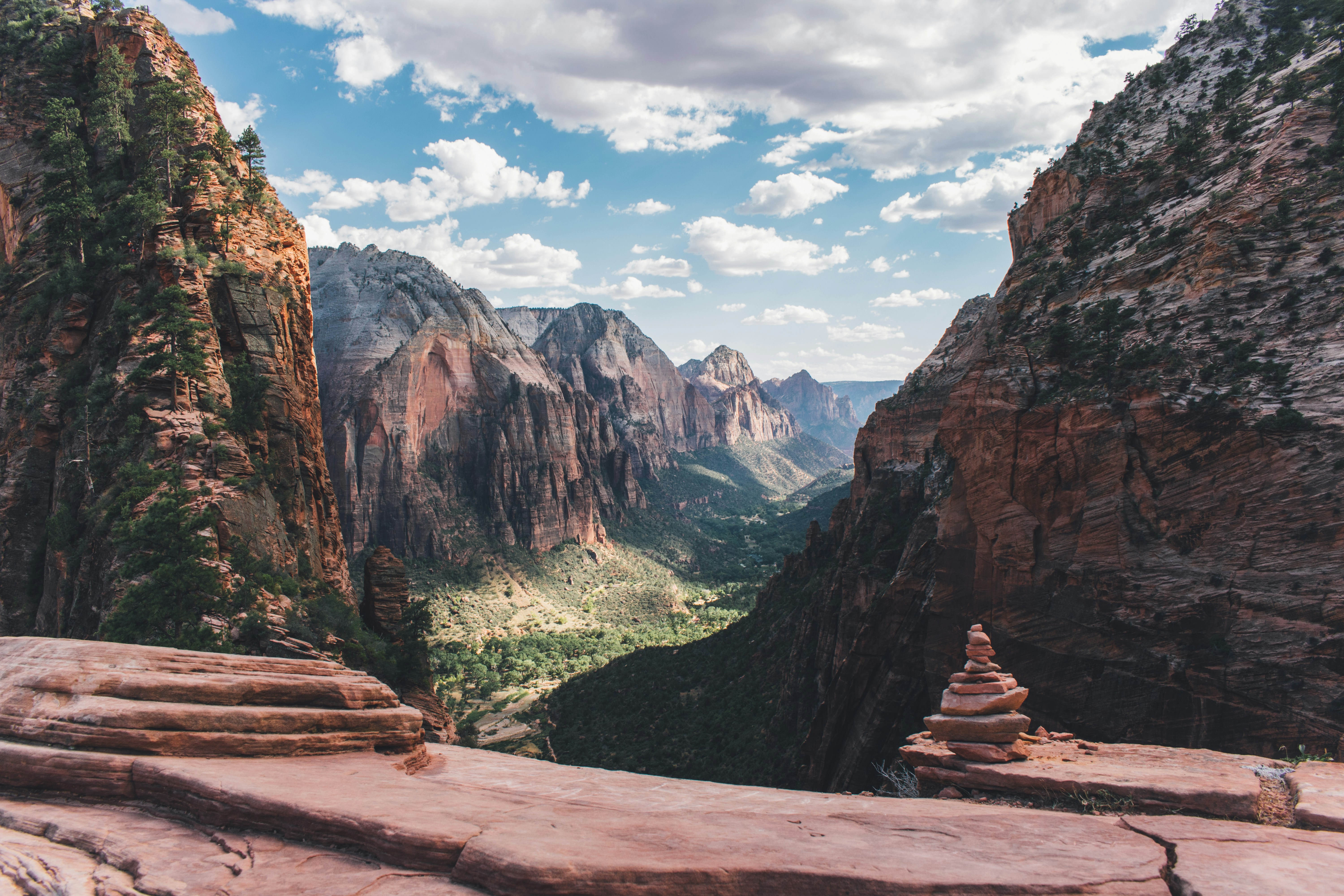pile of stones on a trail in front of sweeping mountains