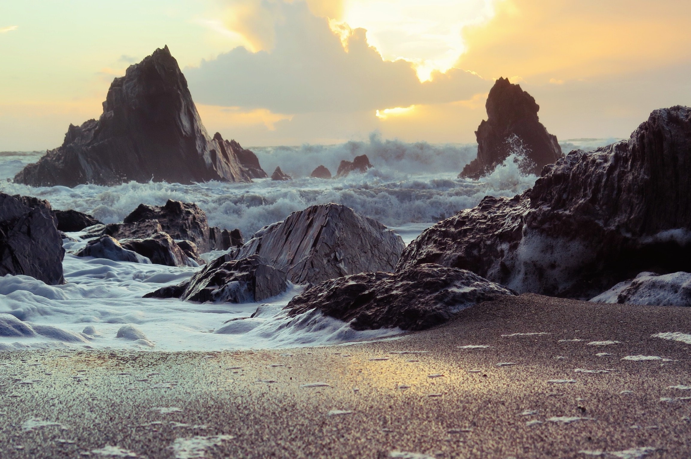 rocks by the seashore at sunset