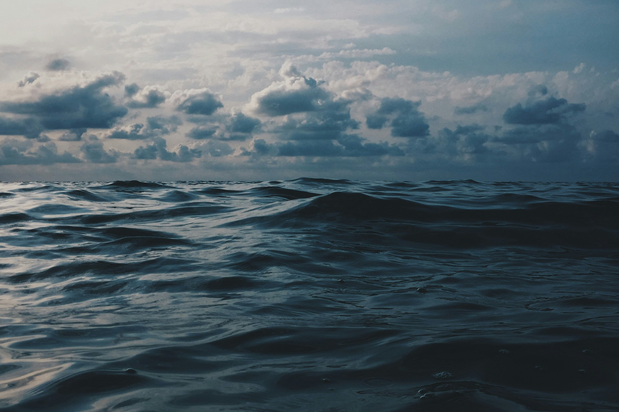 clouds at the horizon of a dark sea