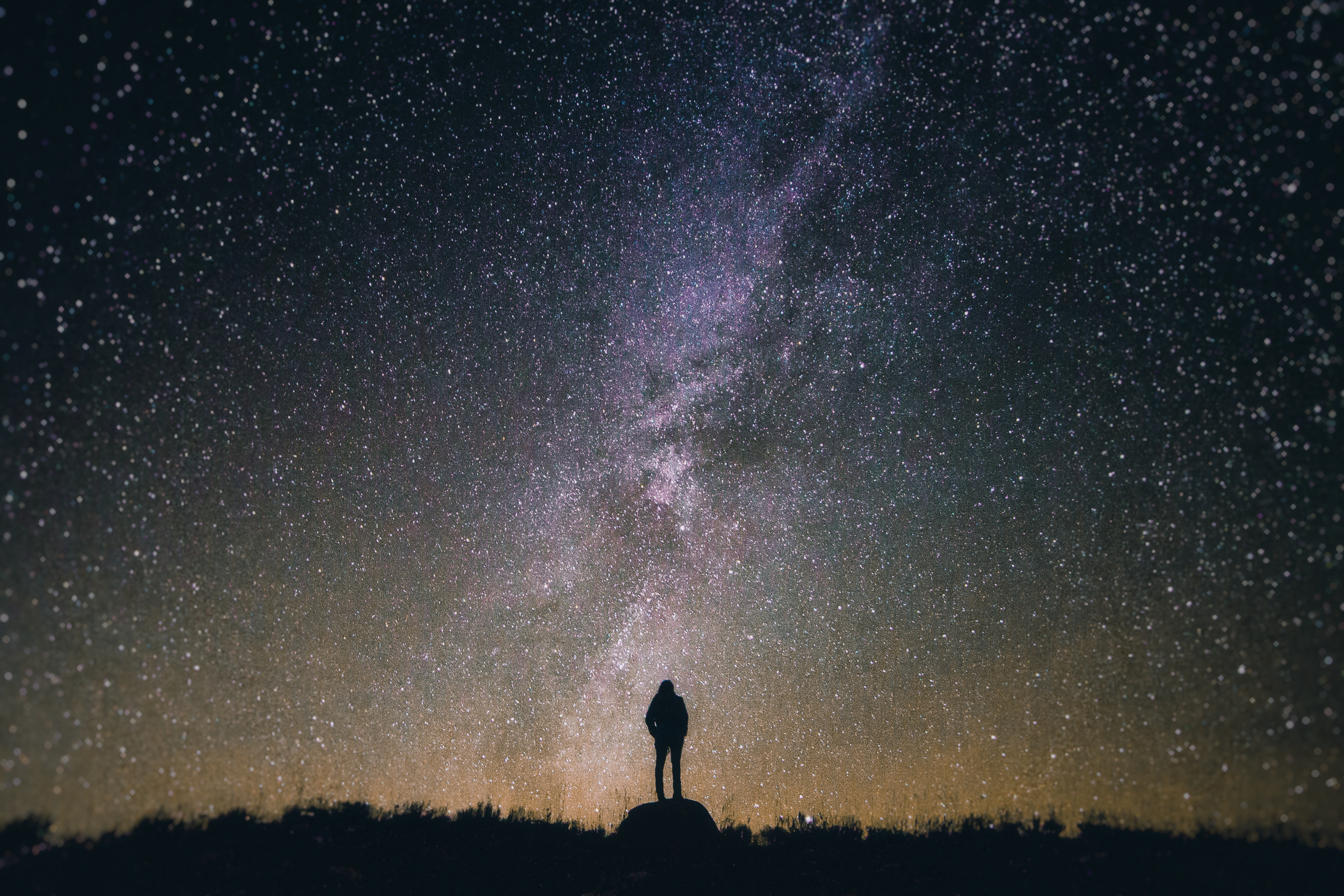 silhouetted person observing night sky