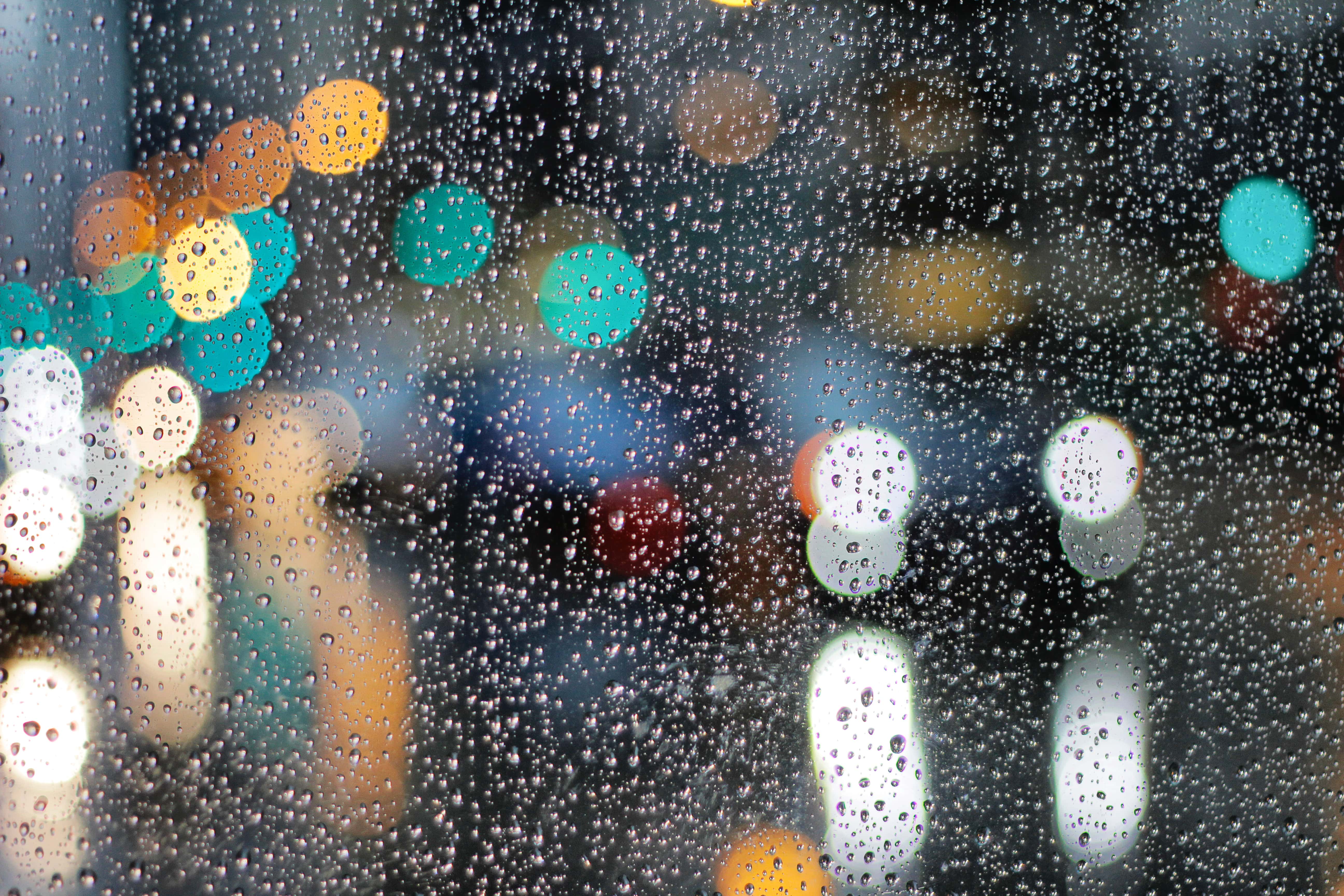 city lights reflected in raindrops on window