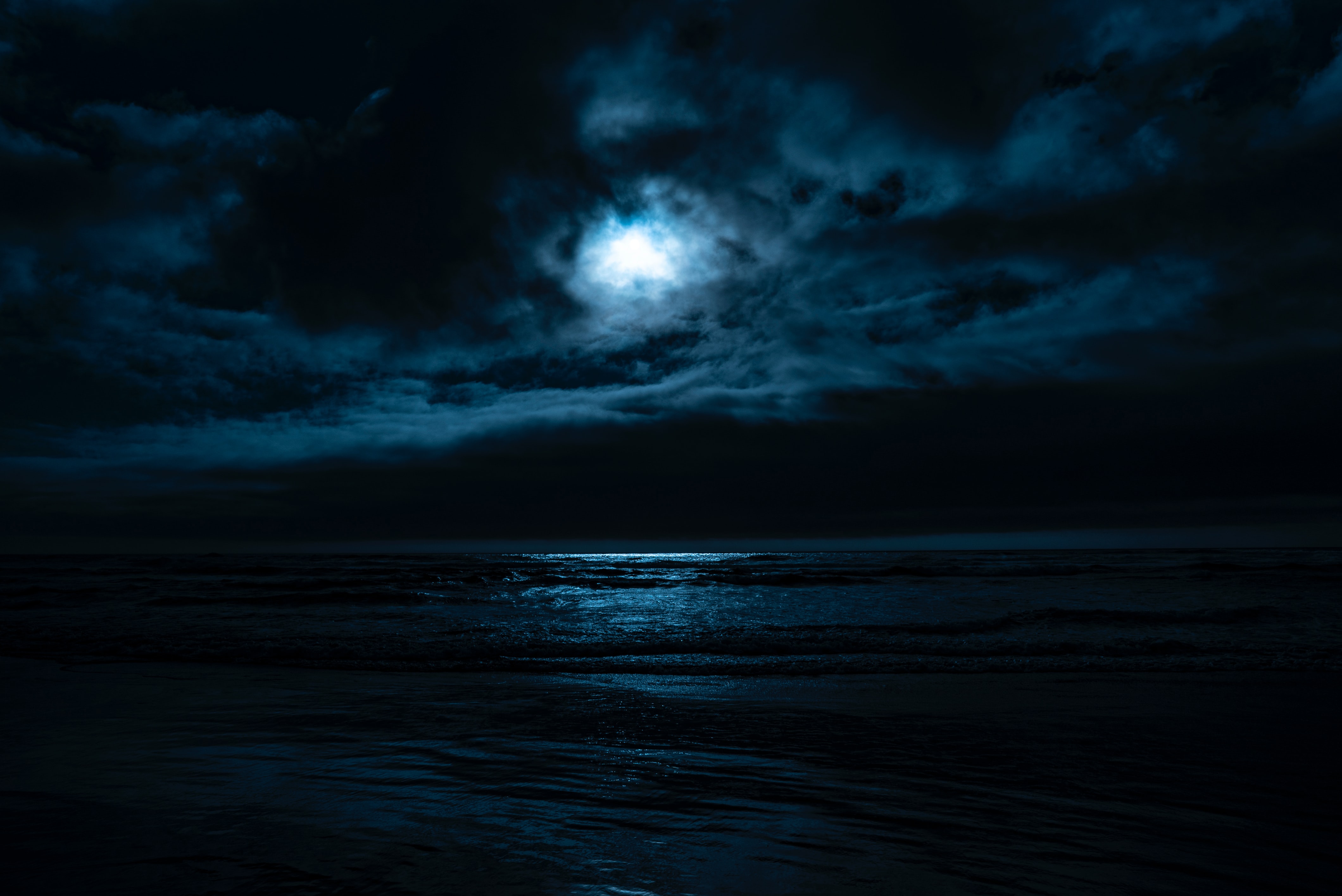 dark misty moonlit night by beach
