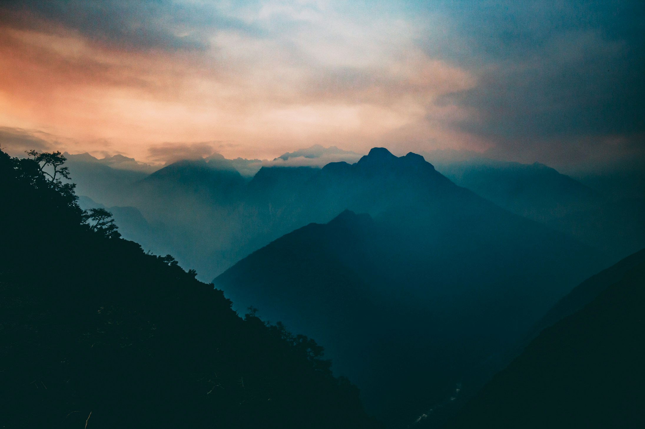 moody sunset or sunrise behind dark mountains