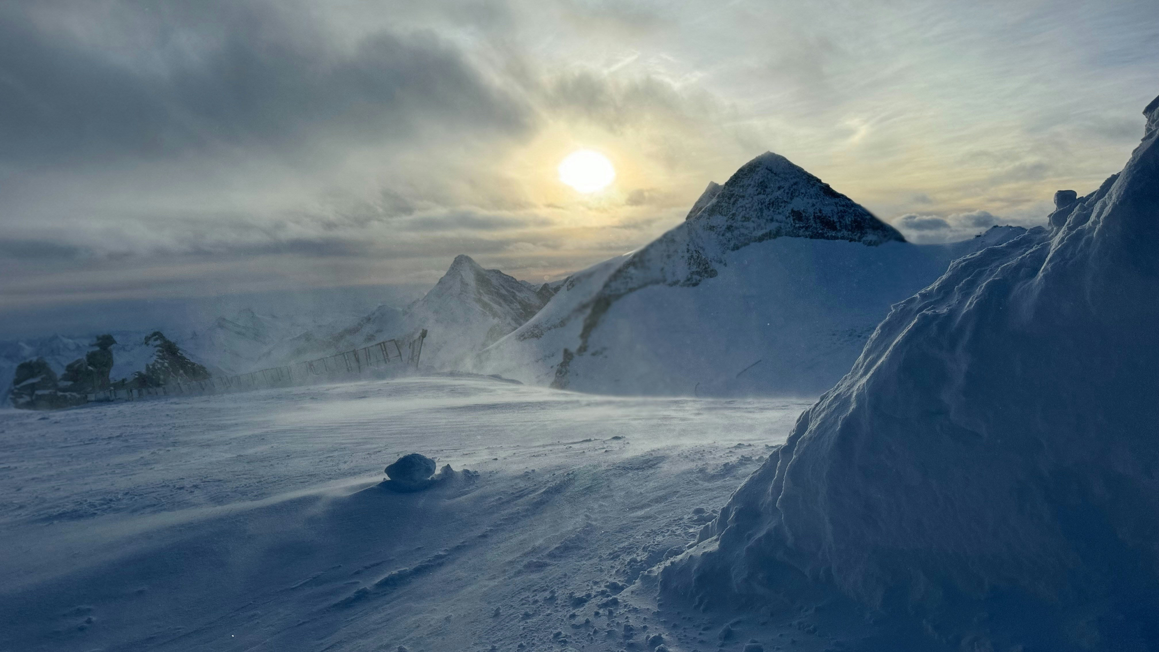 sun rising over snowy mountains