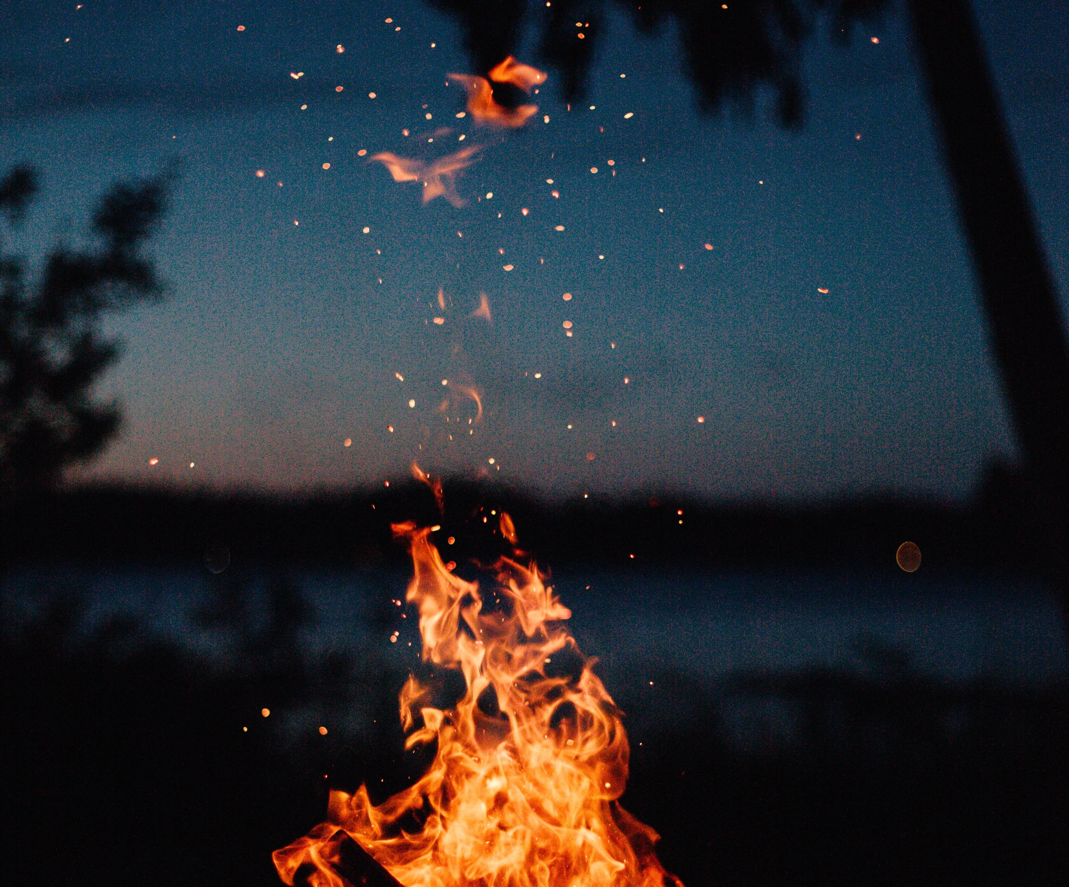 fire sparks against dark water/sky background