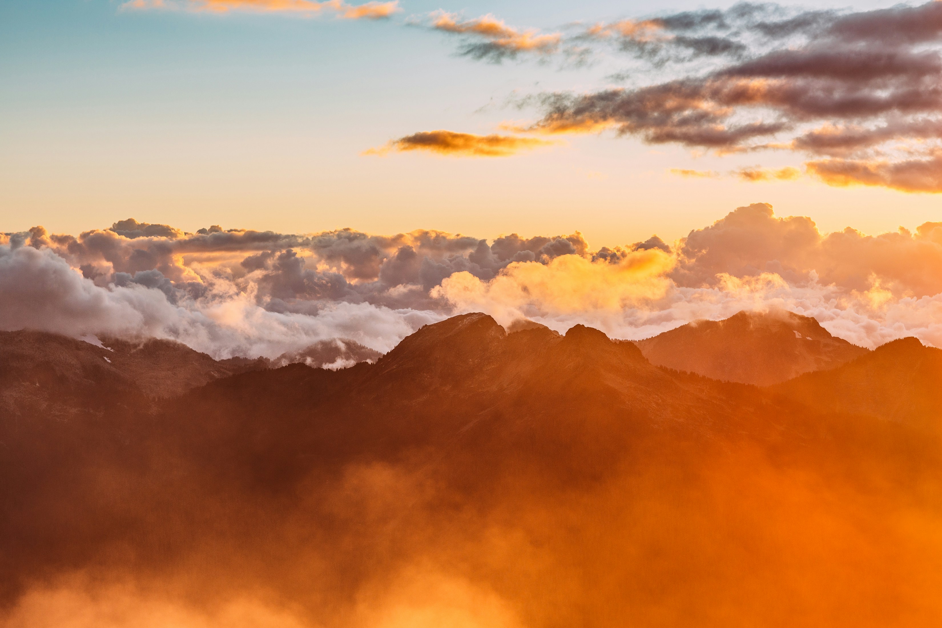 gold and orange sky over mountains