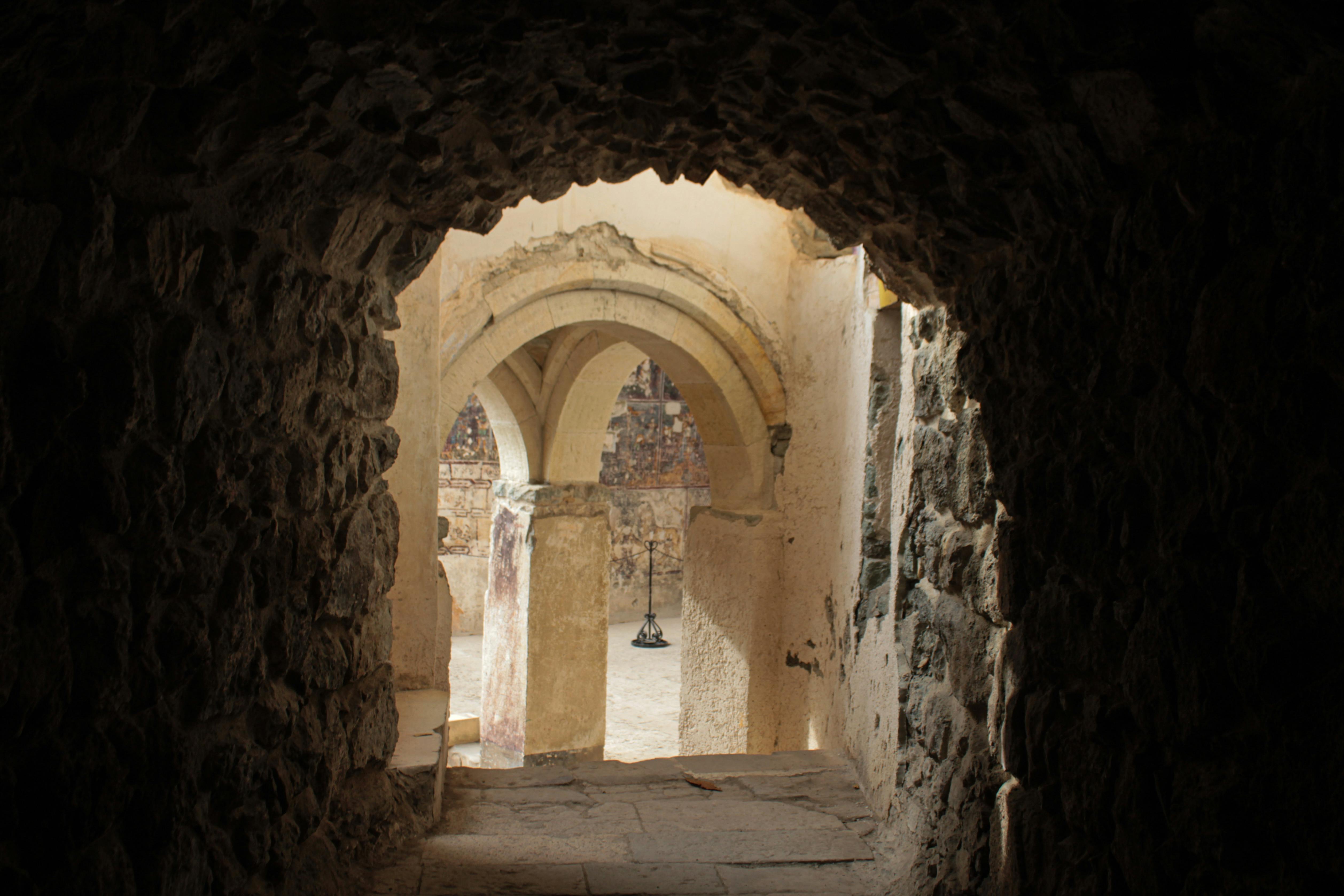 dark passageway opening to reveal chandalier