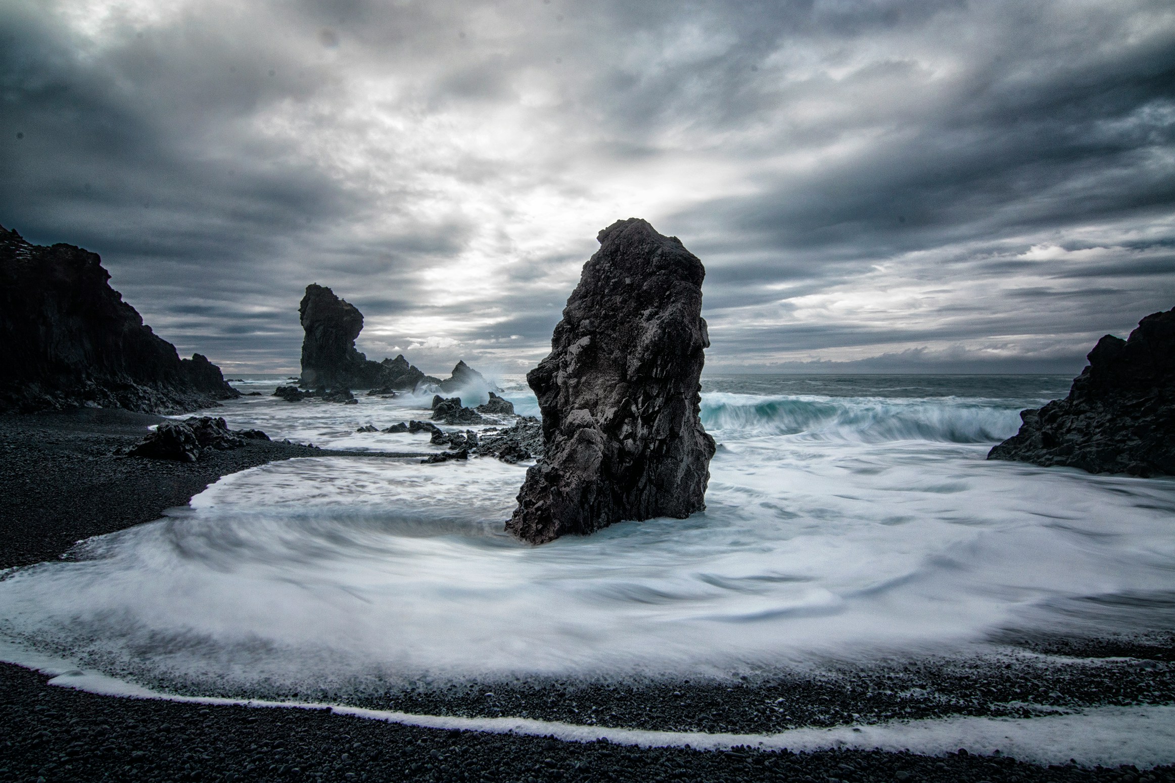 dark foamy seas aroudn dark rocks