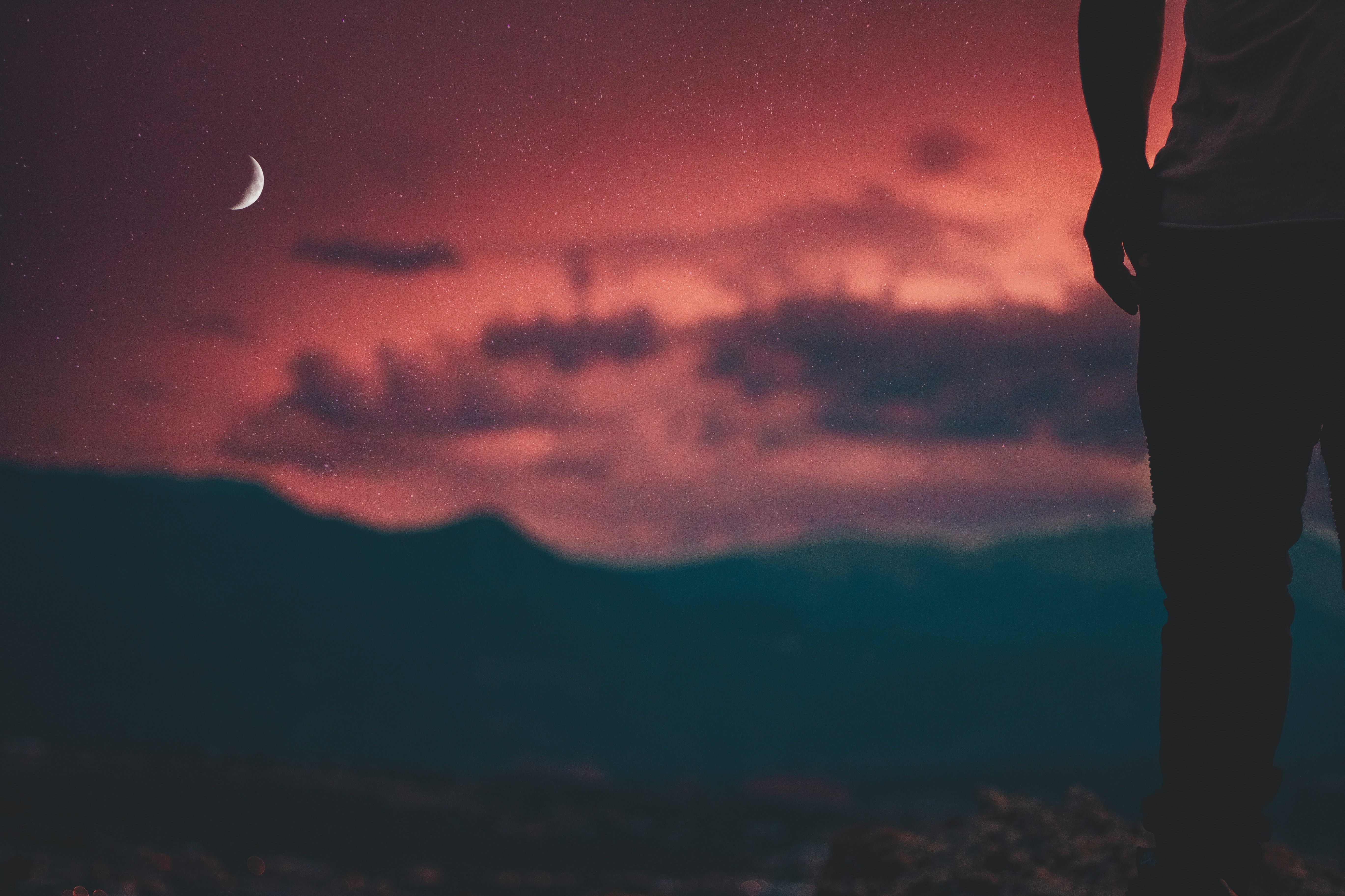 man looking at moon in sky