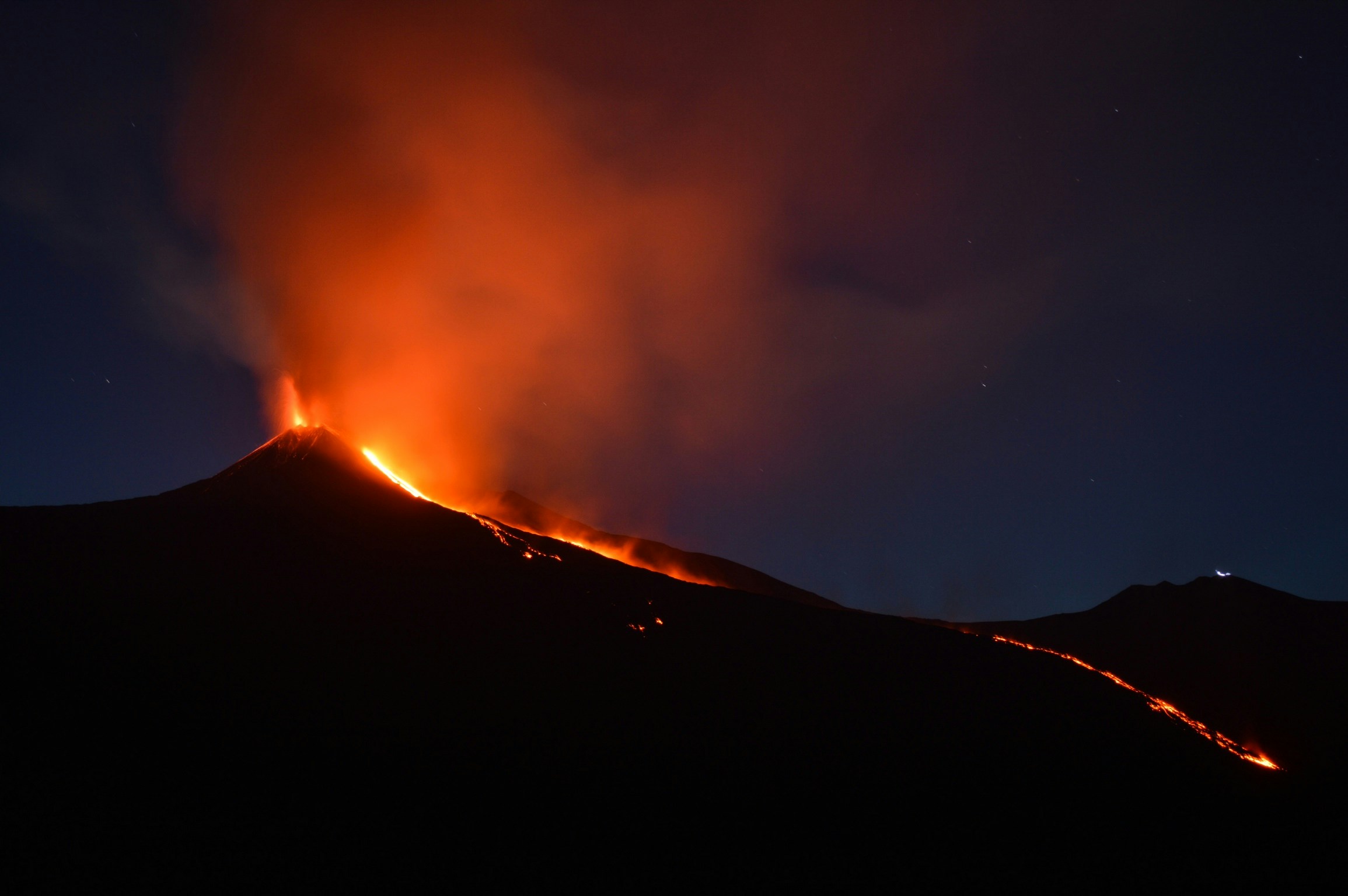 lava lighting up edge of a dark mnt etna