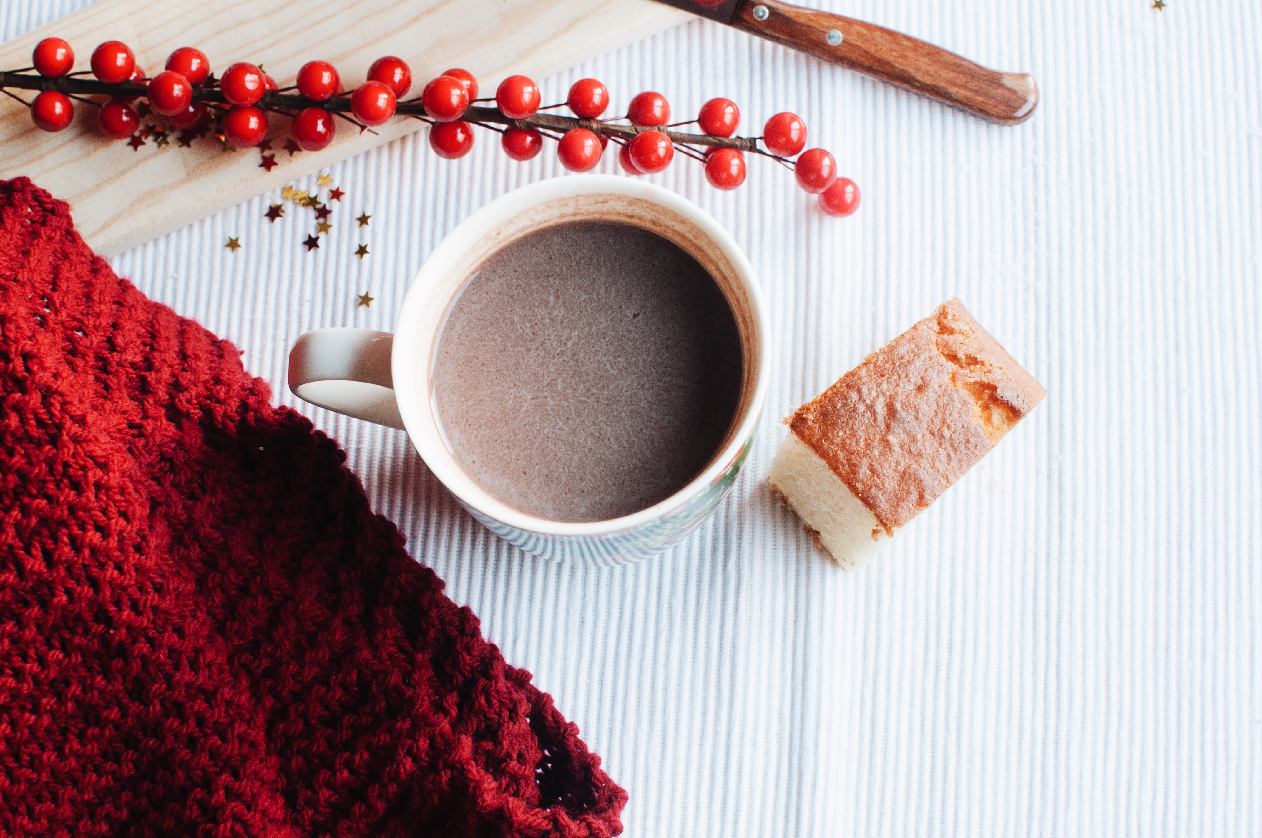 cup of hot chocolate and red fabric