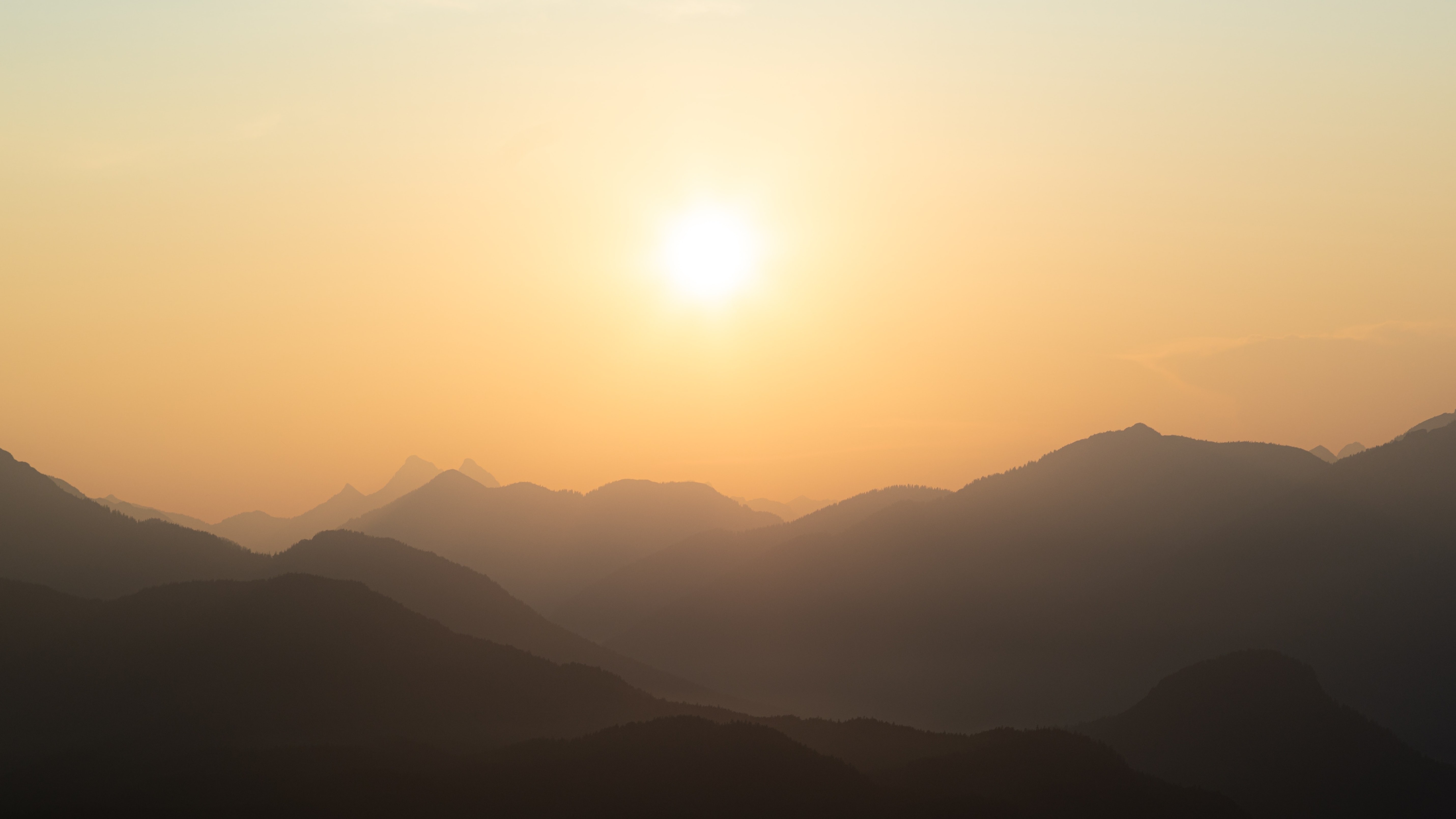 golden yellow sunrise over misty mountains