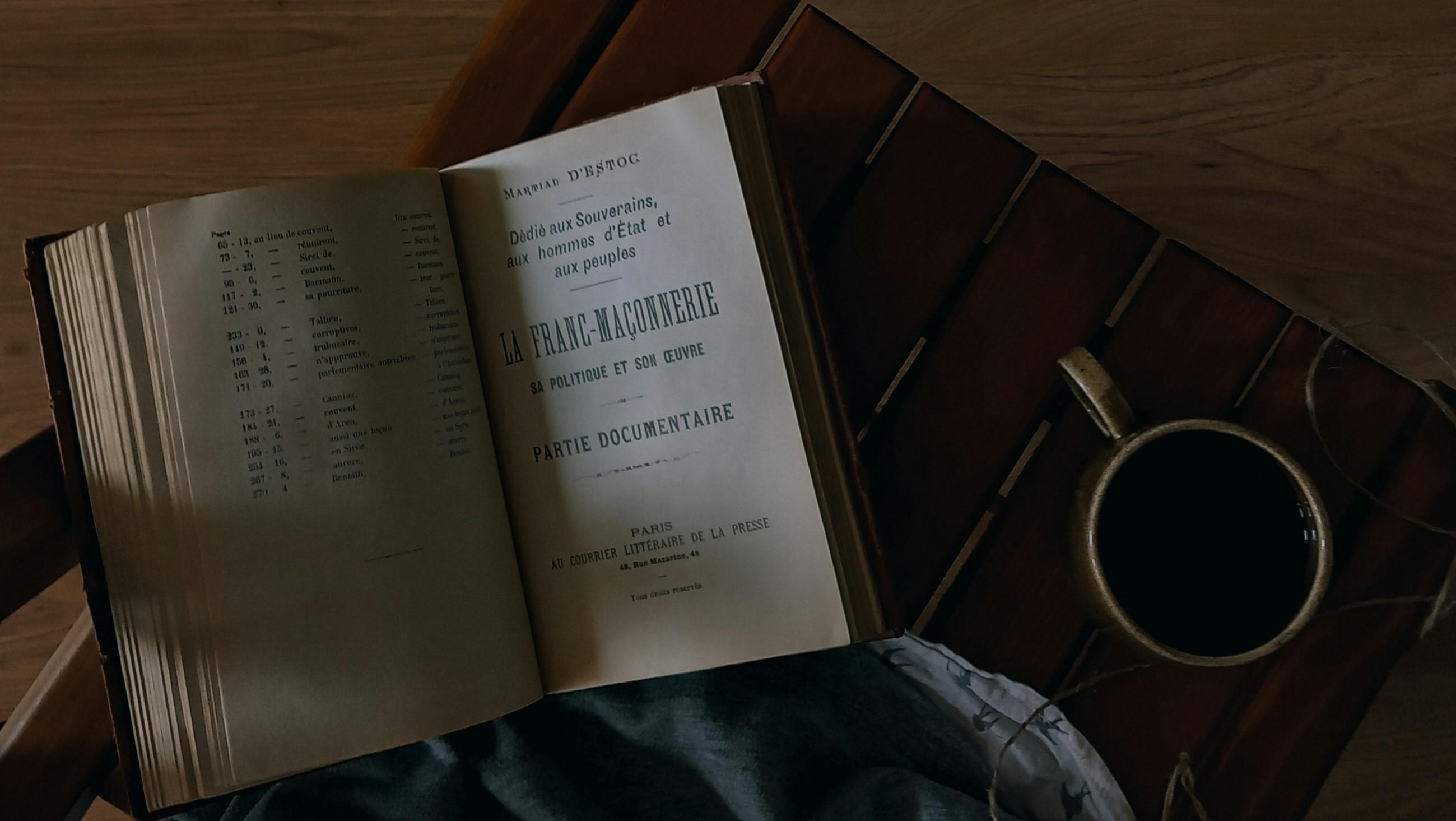 an open book and tea nearby, dark green theme