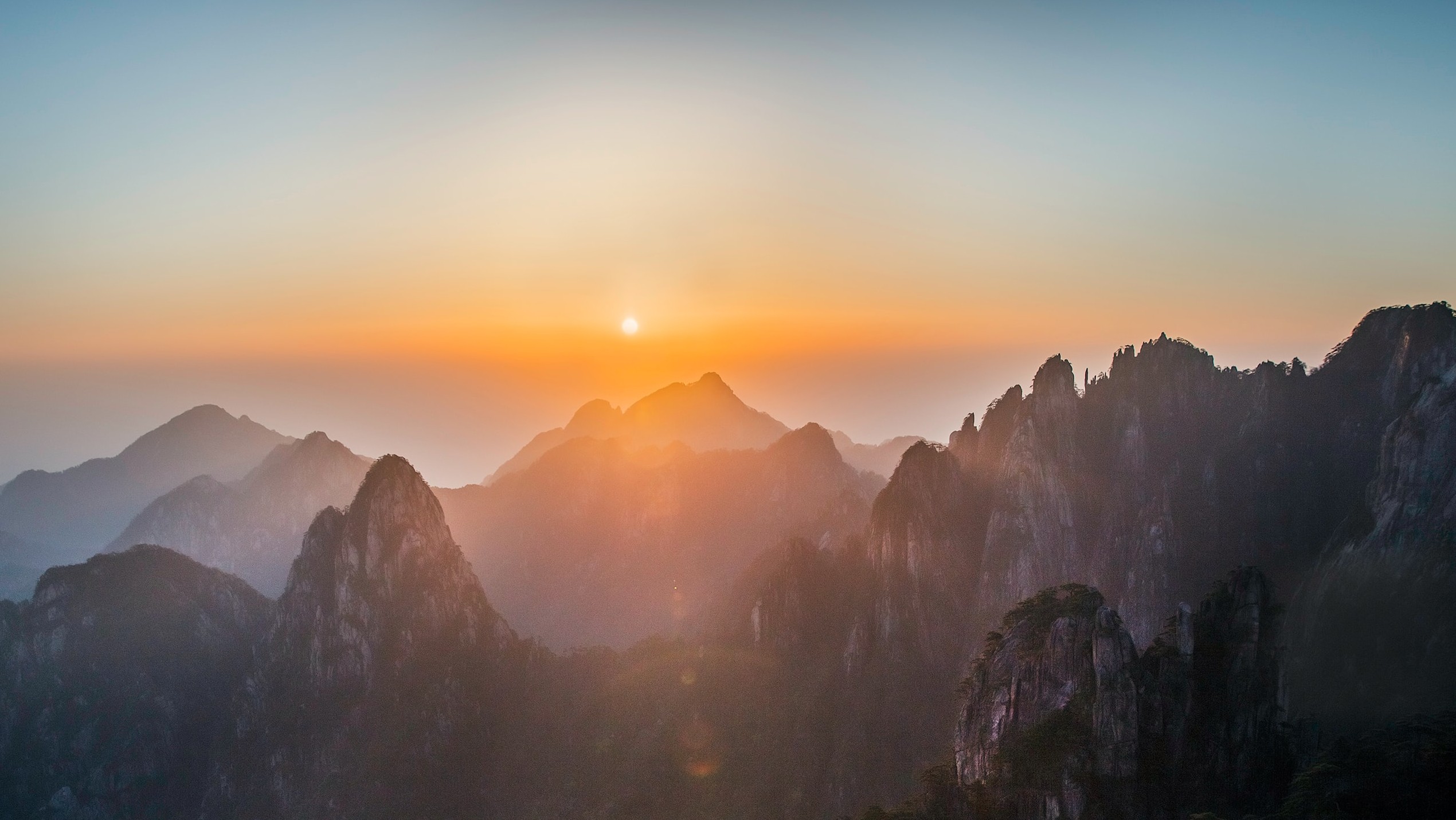 sun cresting over mountains