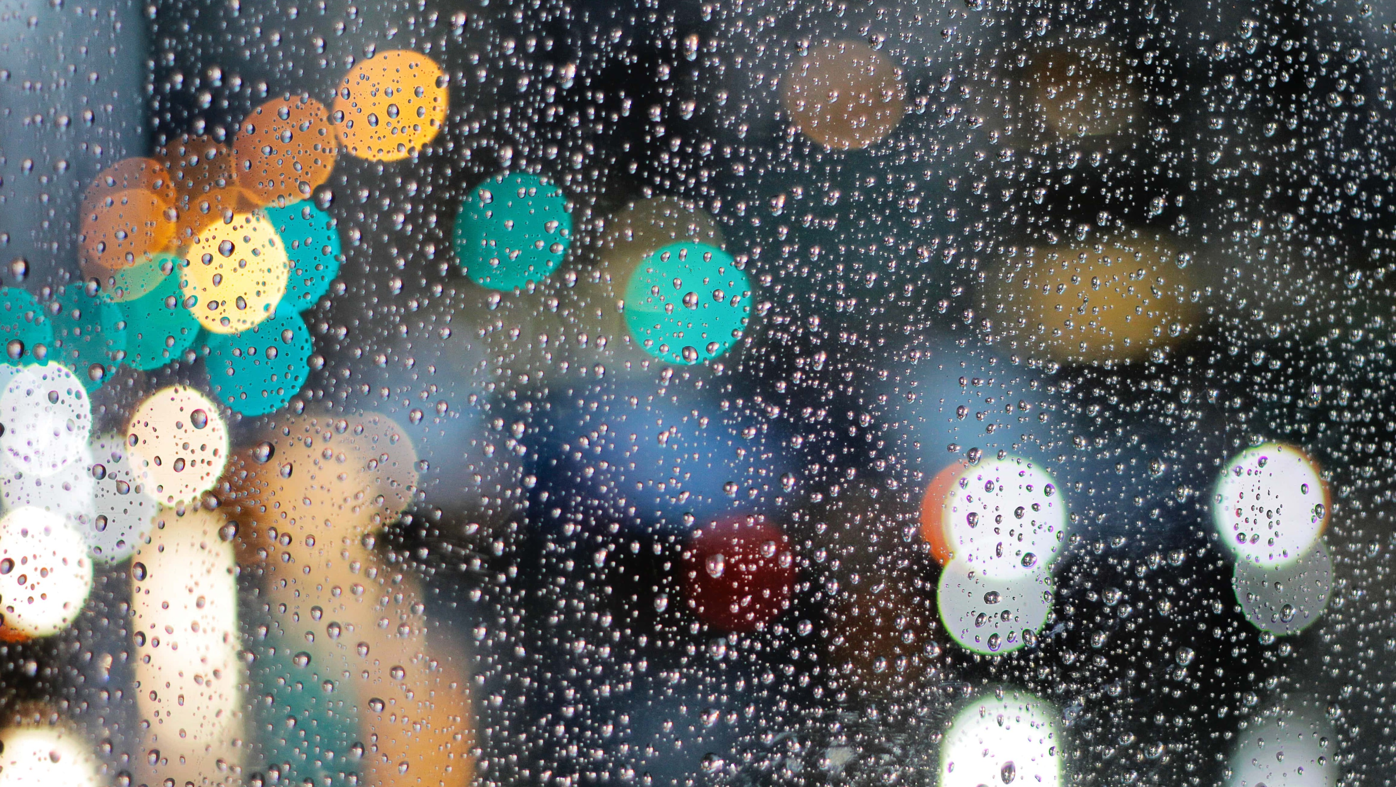 city lights reflected in raindrops on window