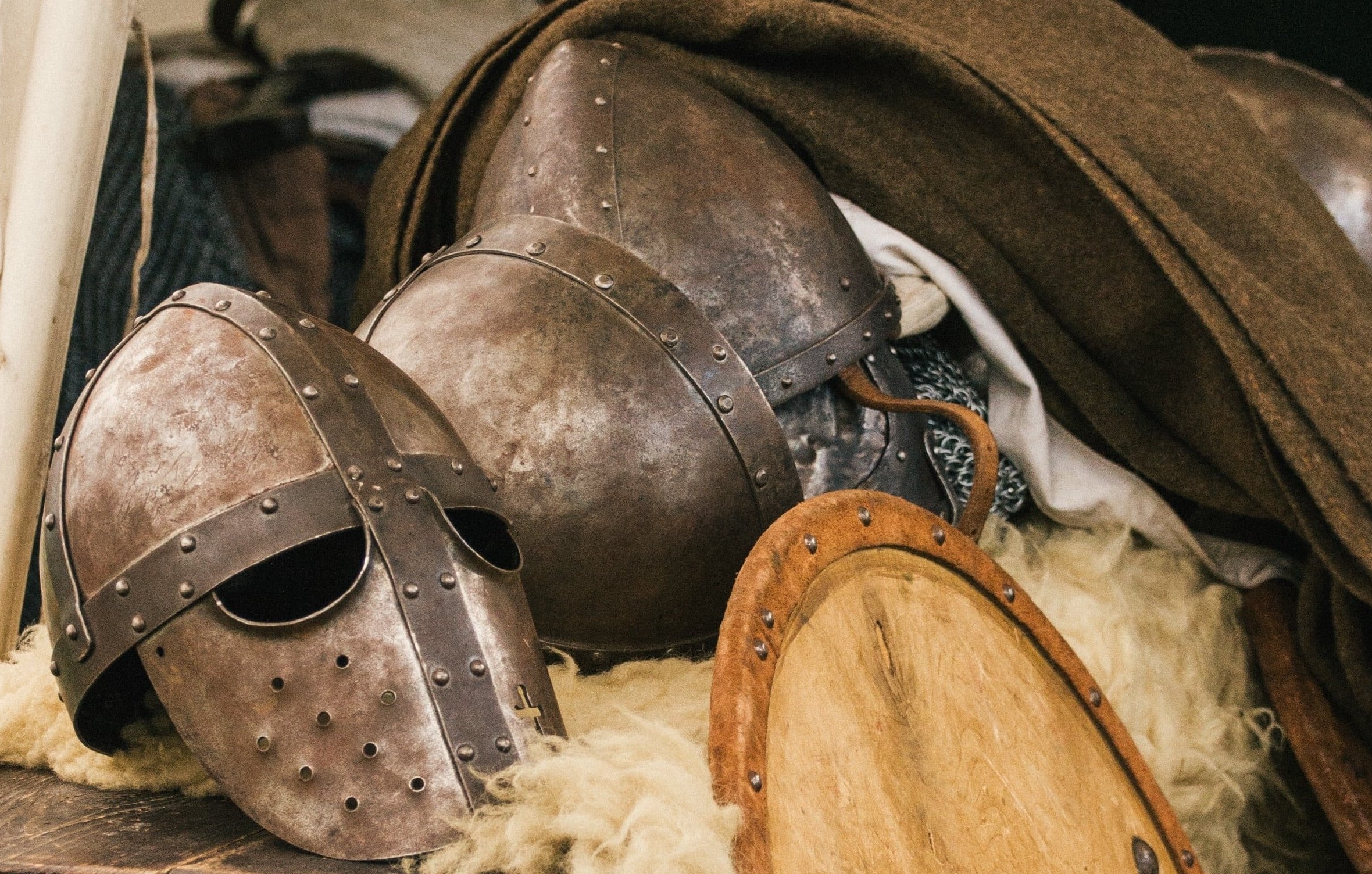 helmet lying beside shield and weapons
