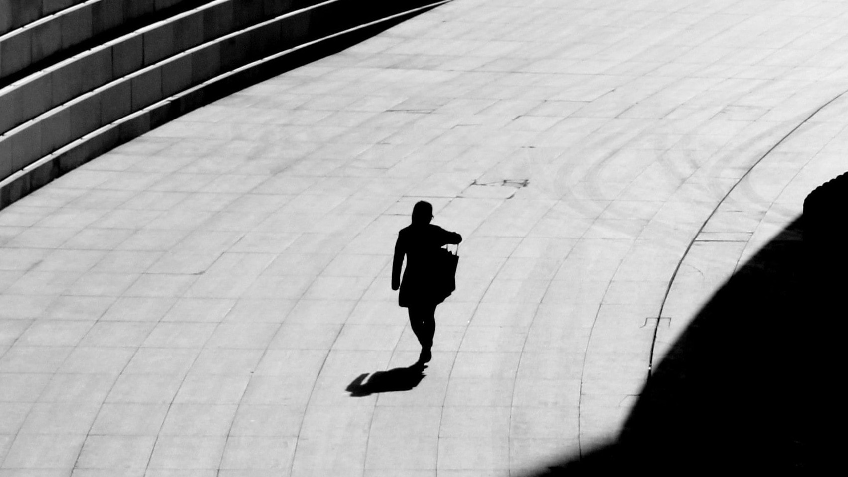 silhouetted person walking alone