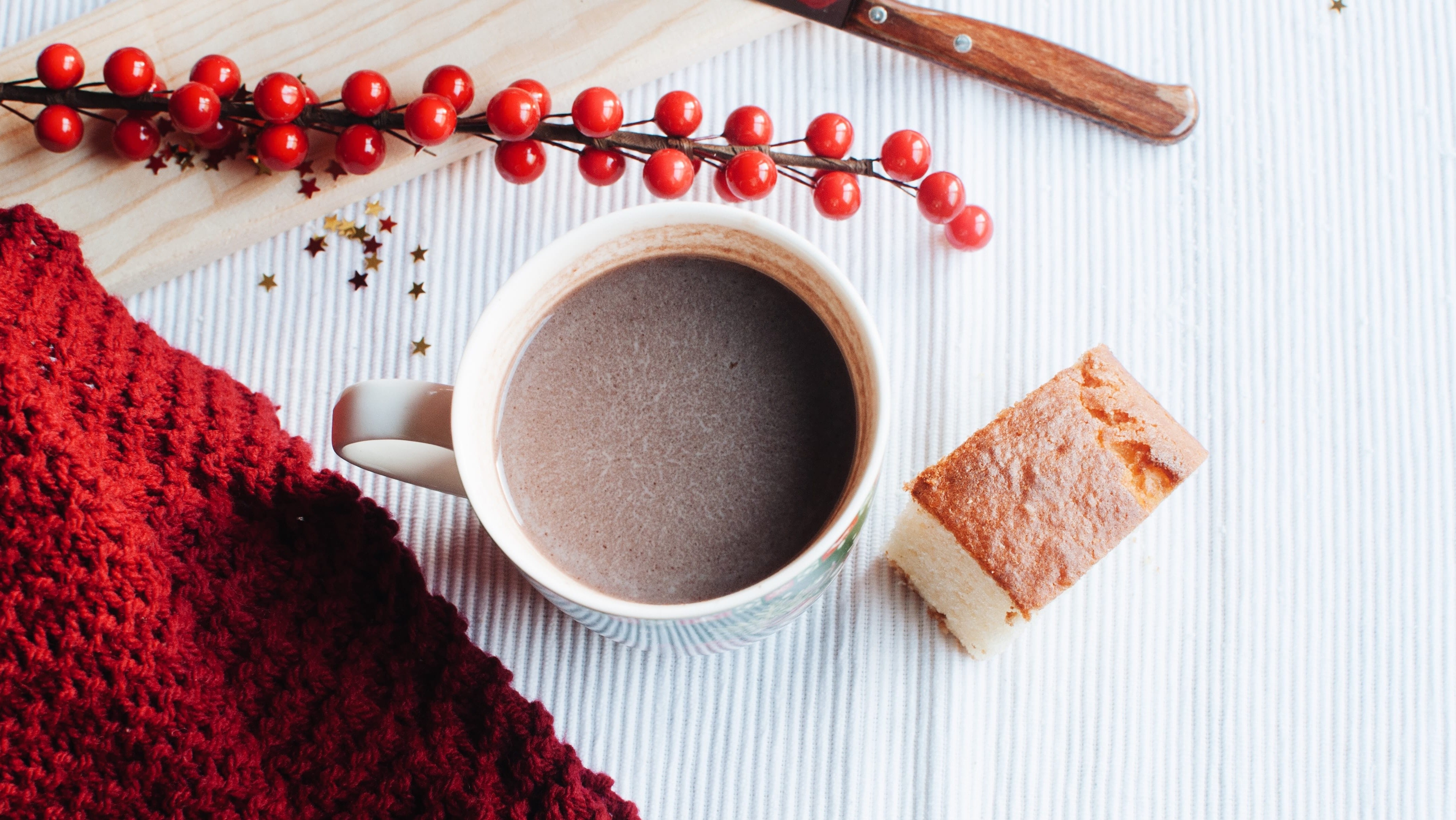 cup of hot chocolate and red fabric
