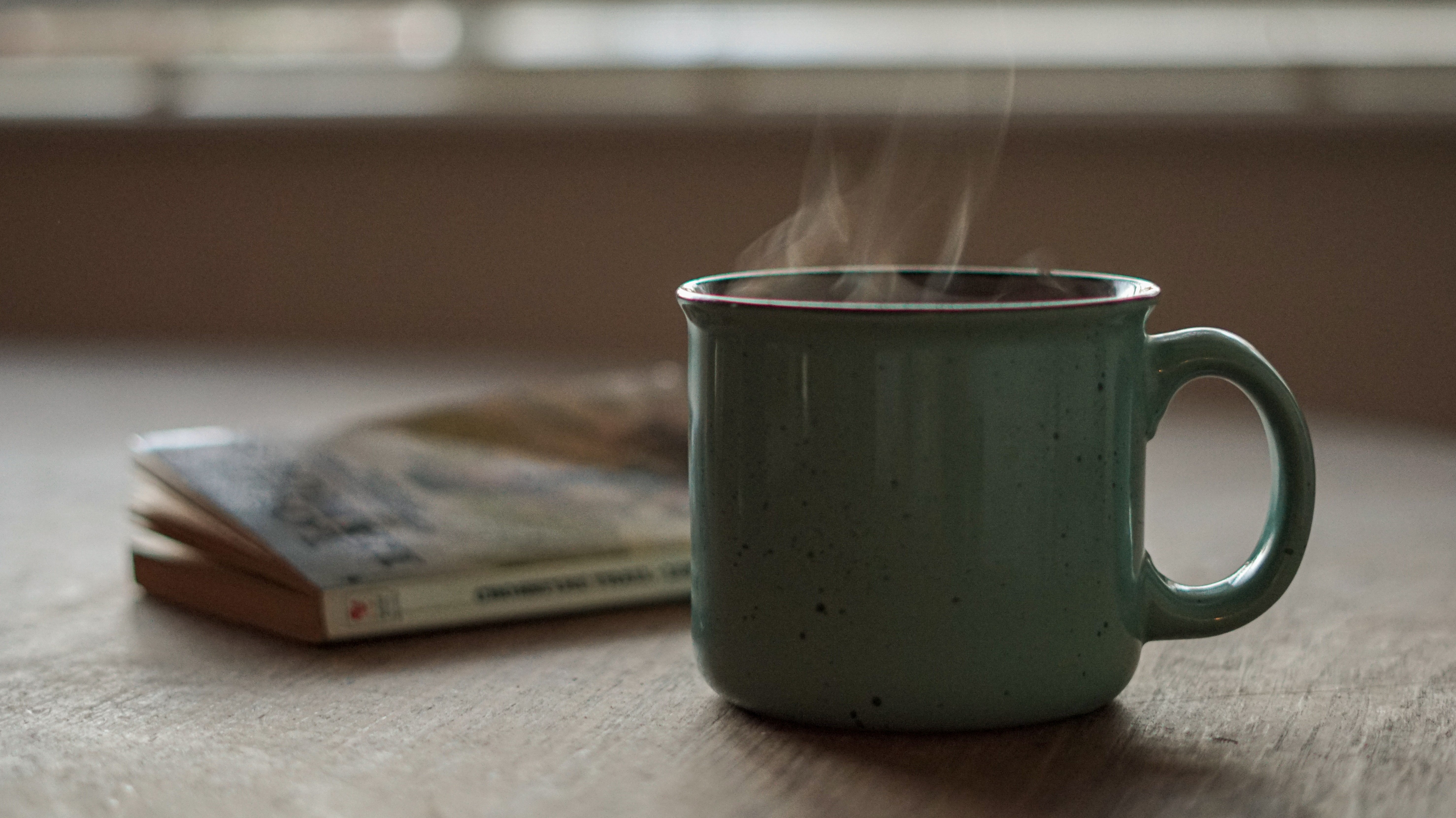 cup of tea or coffee by a book