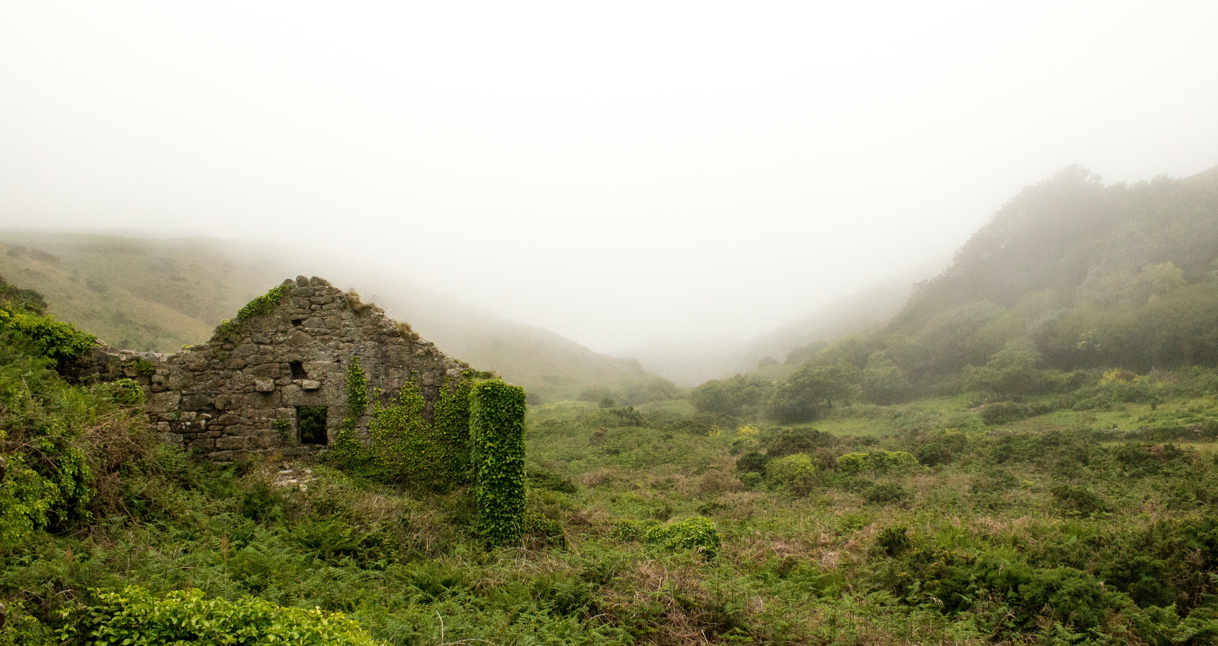 old house built of stone in misty countryside