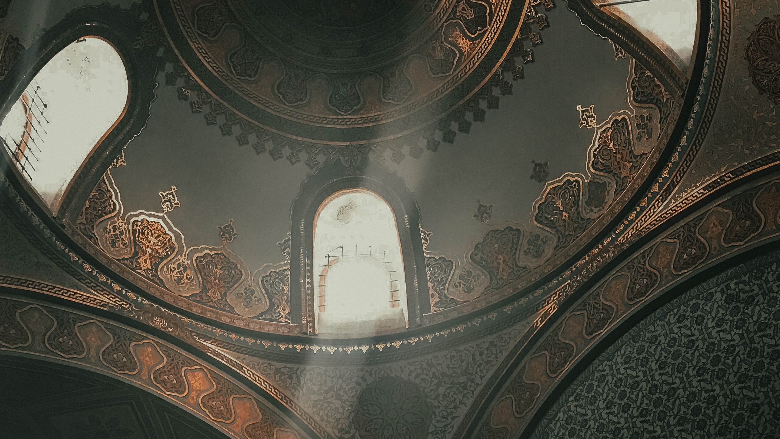 dim-lit interior of mosque ceiling