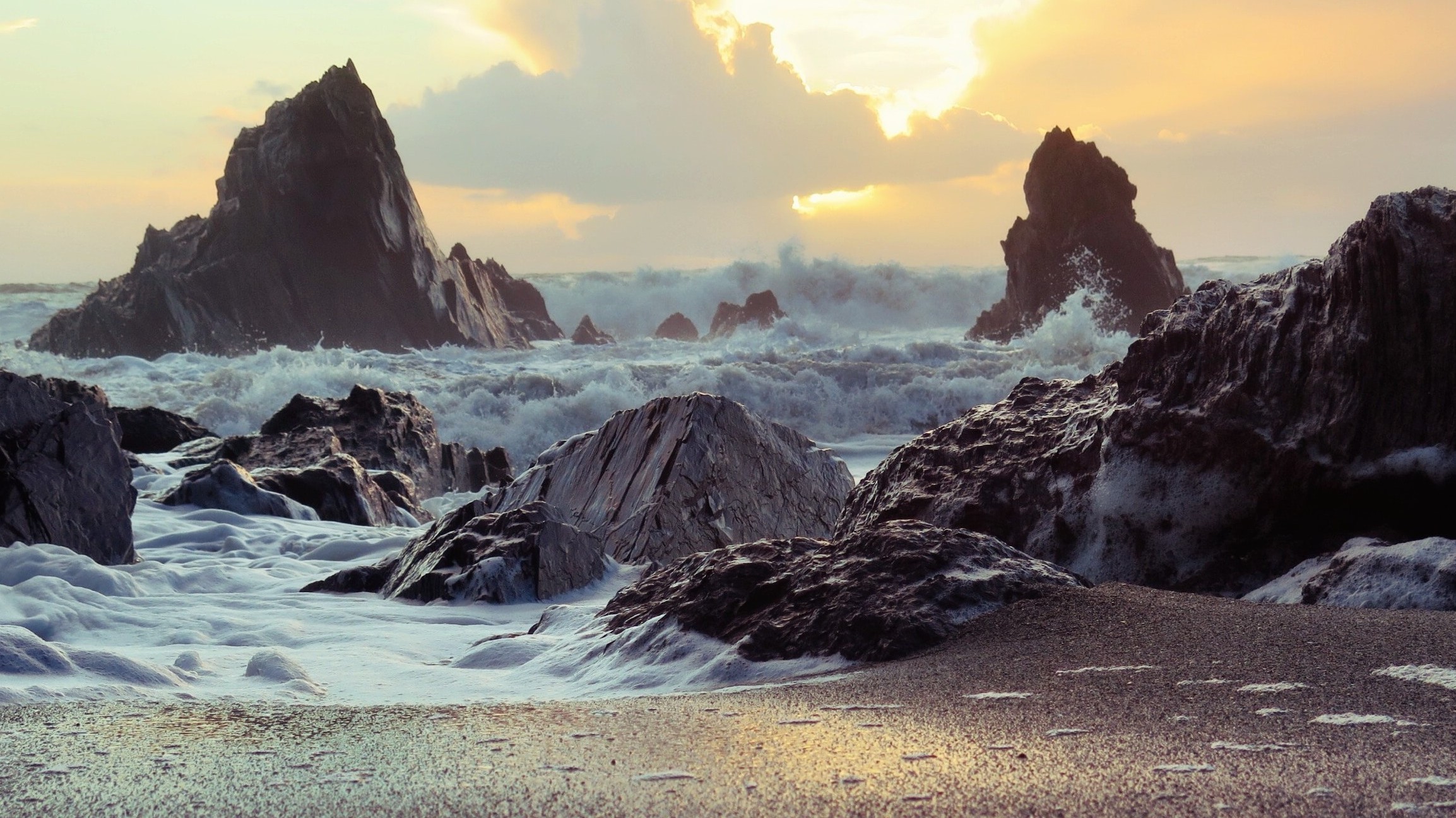 rocks by the seashore at sunset