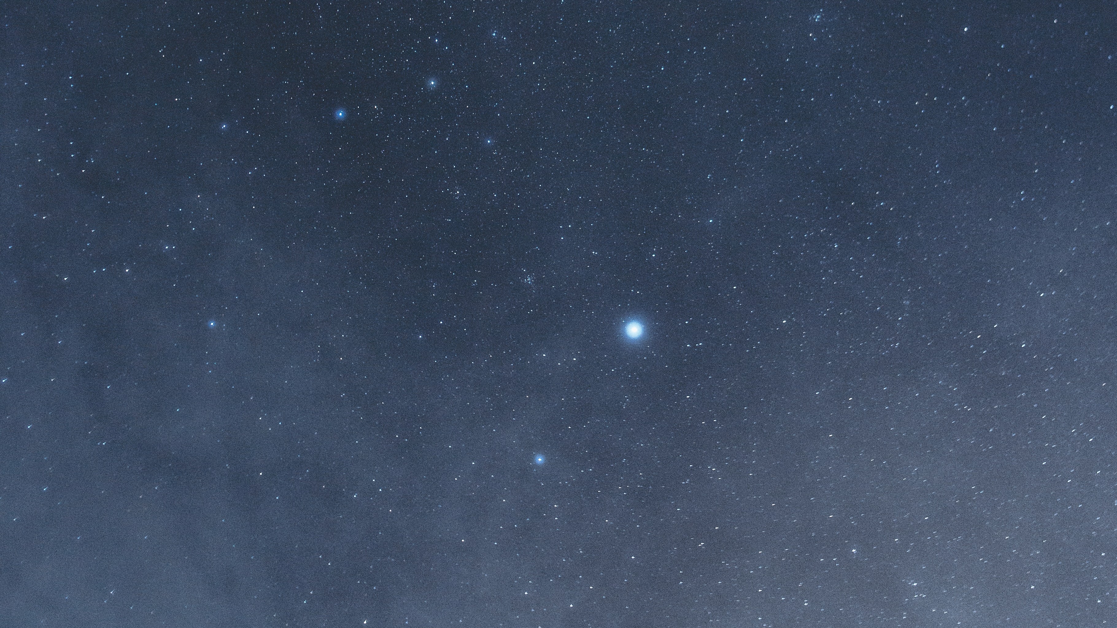 a single star in a dusty blue sky