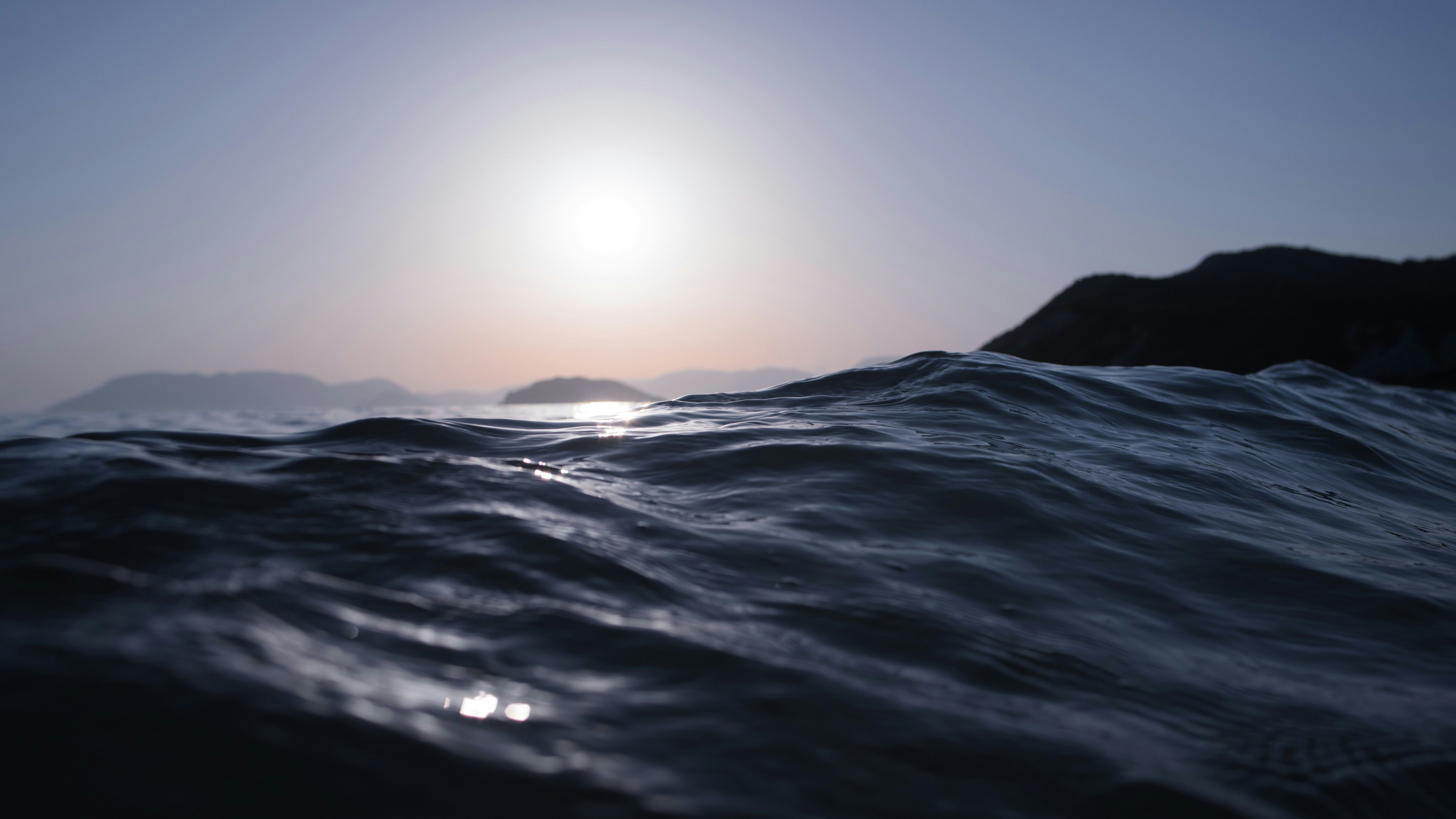 churning dark waves against a sky horizon