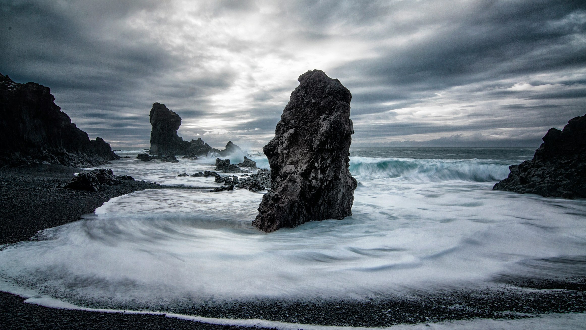 dark foamy seas aroudn dark rocks