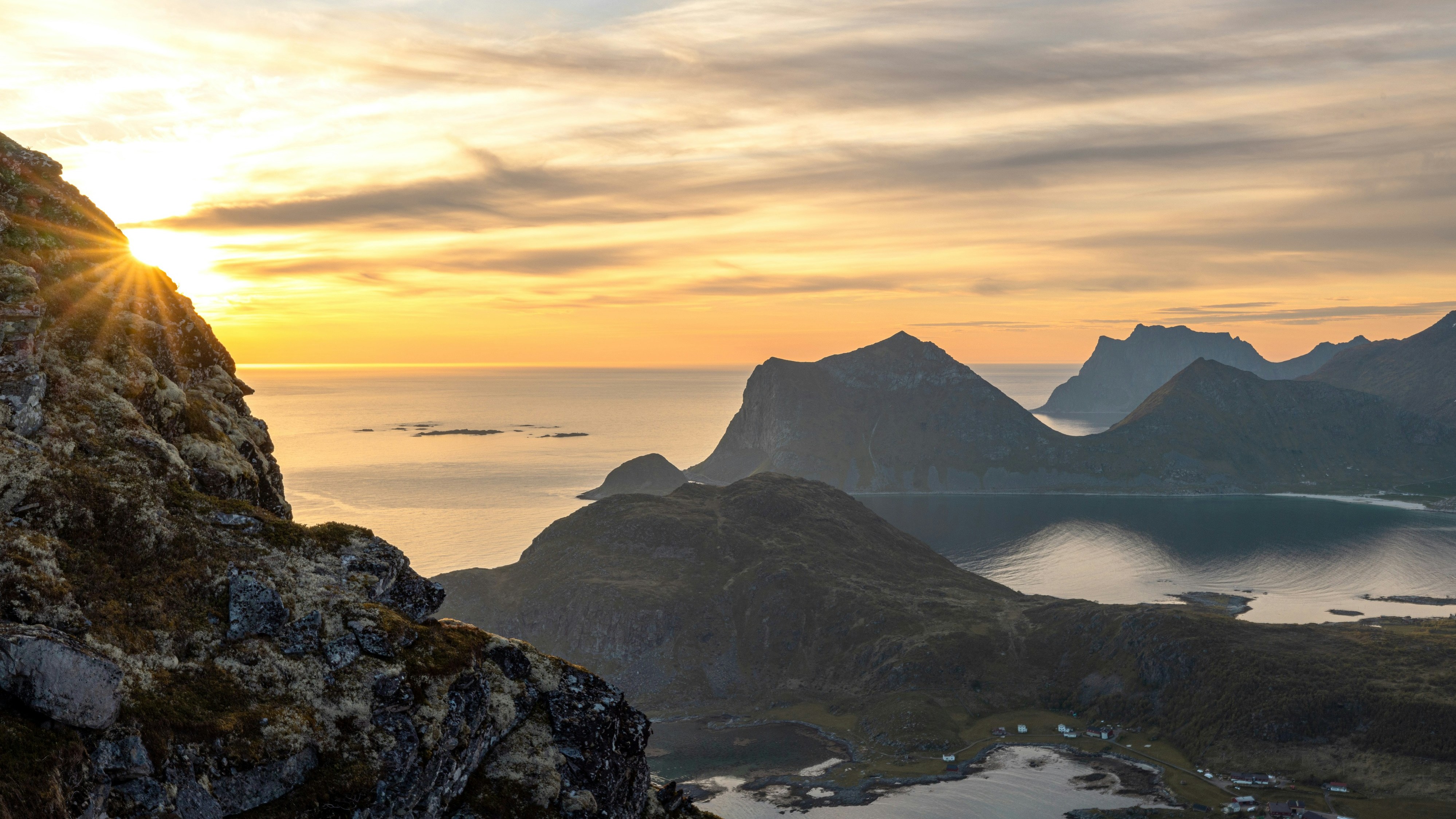 sun cresting over sharp rocky crags