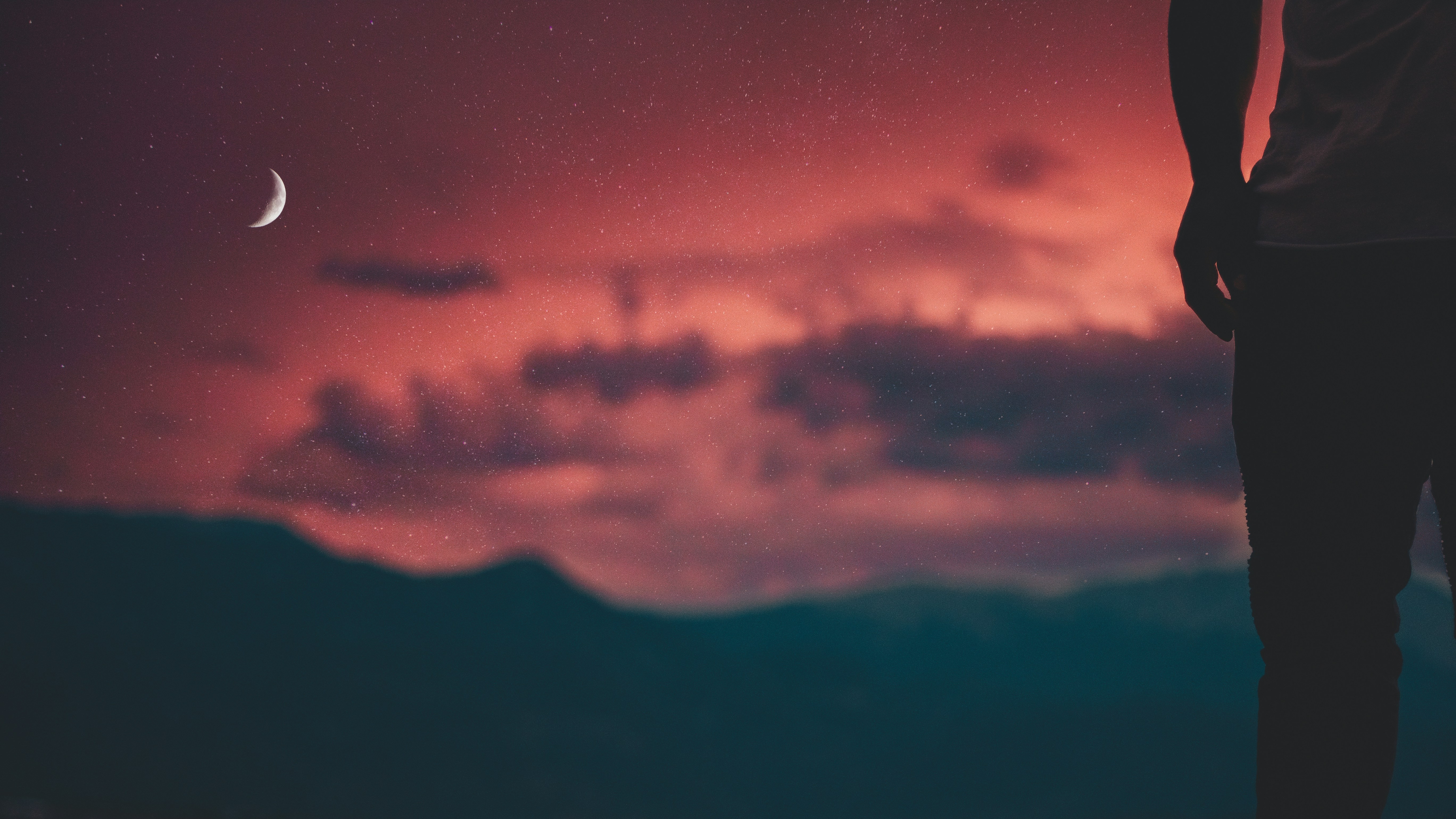 man looking at moon in sky