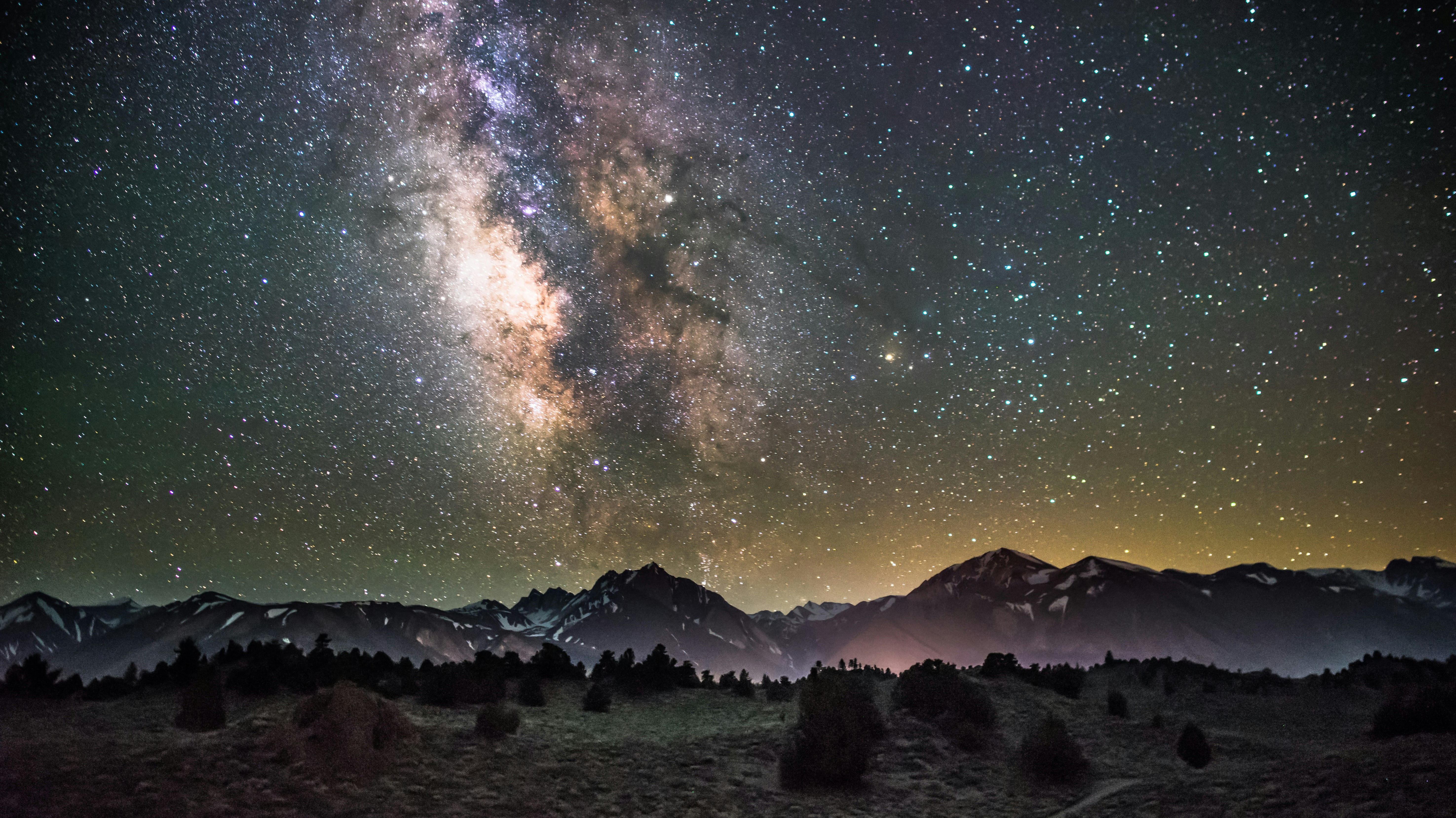 milky way and night sky over mountains