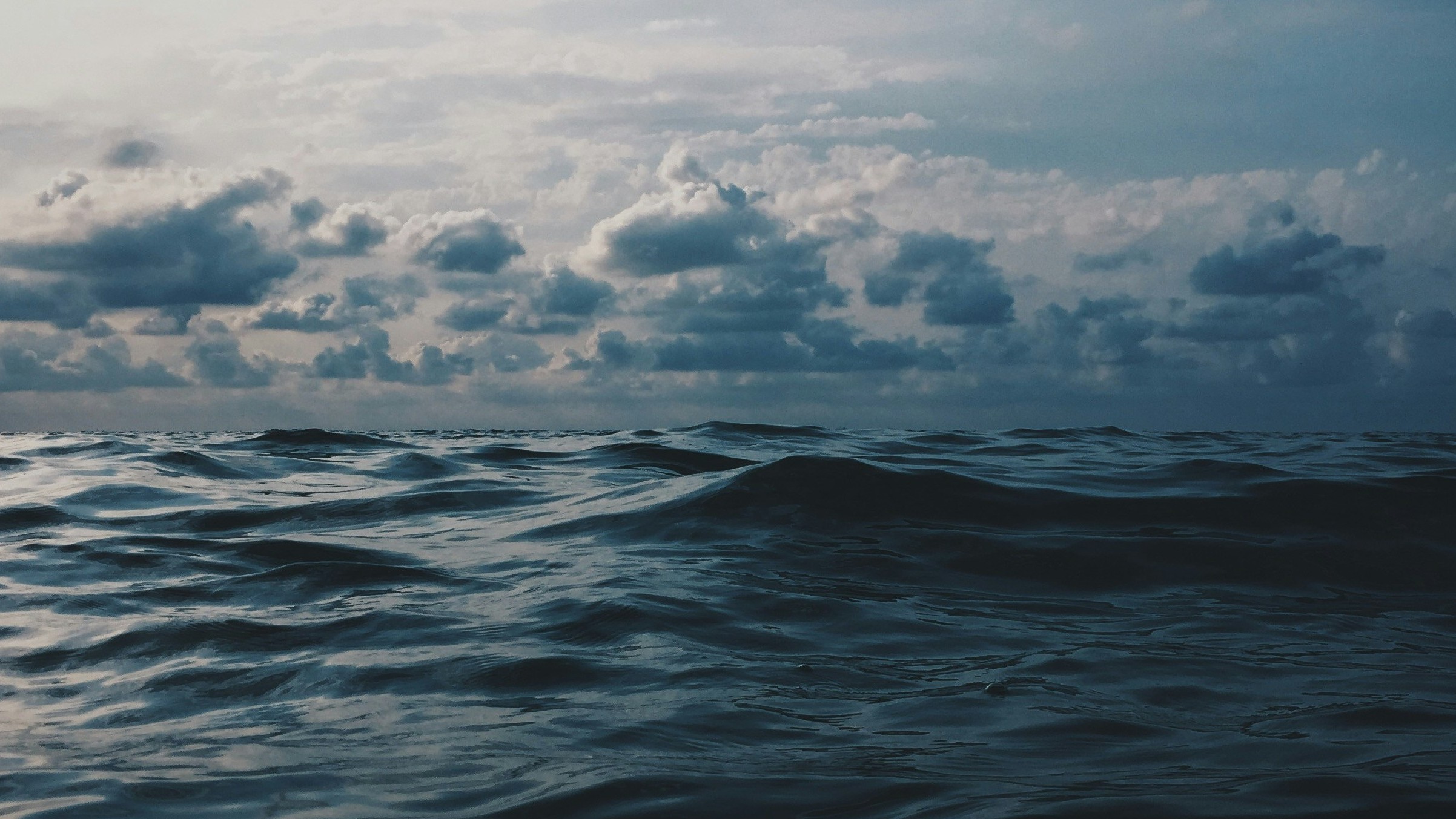 clouds at the horizon of a dark sea
