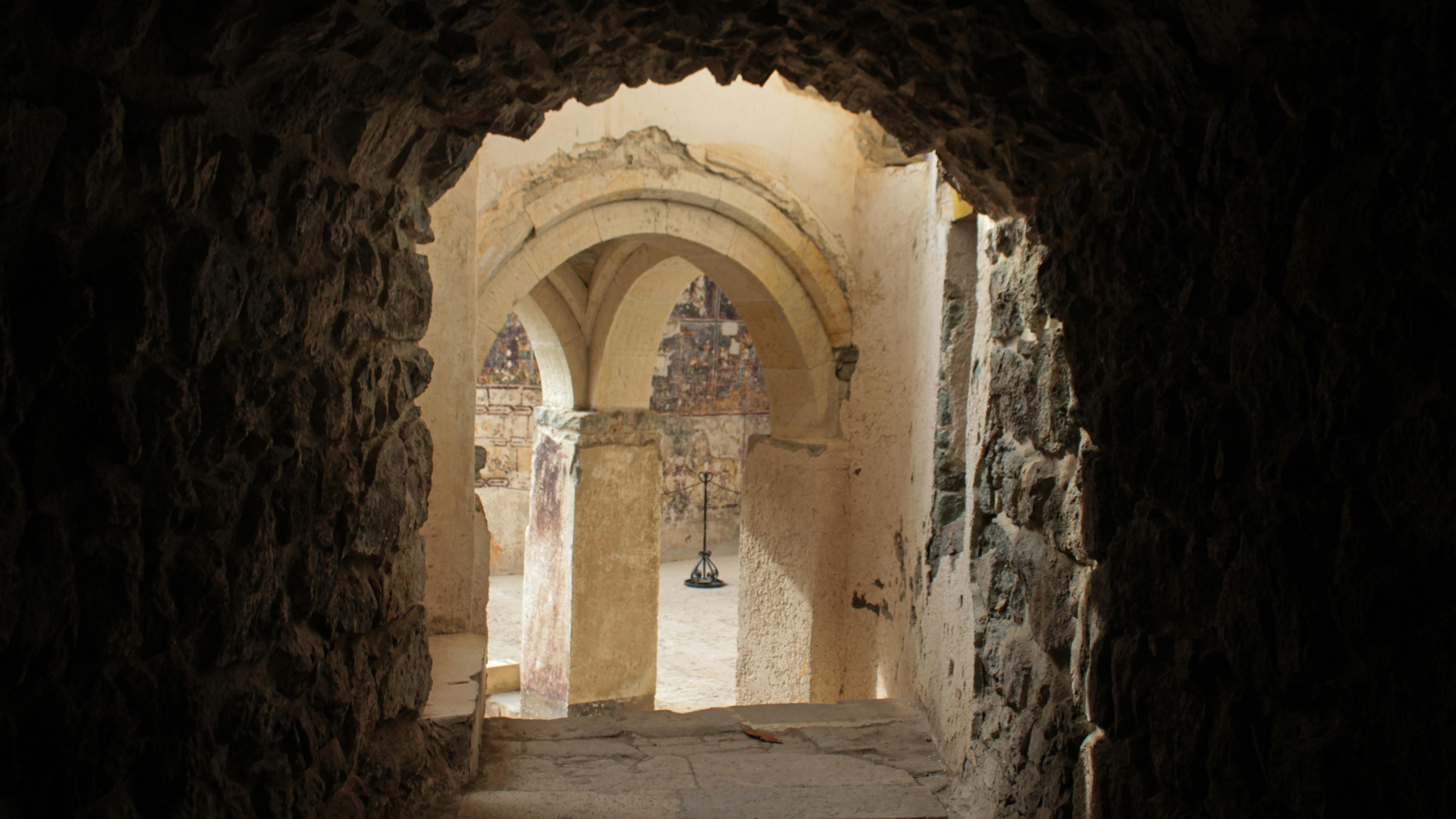 dark passageway opening to reveal chandalier