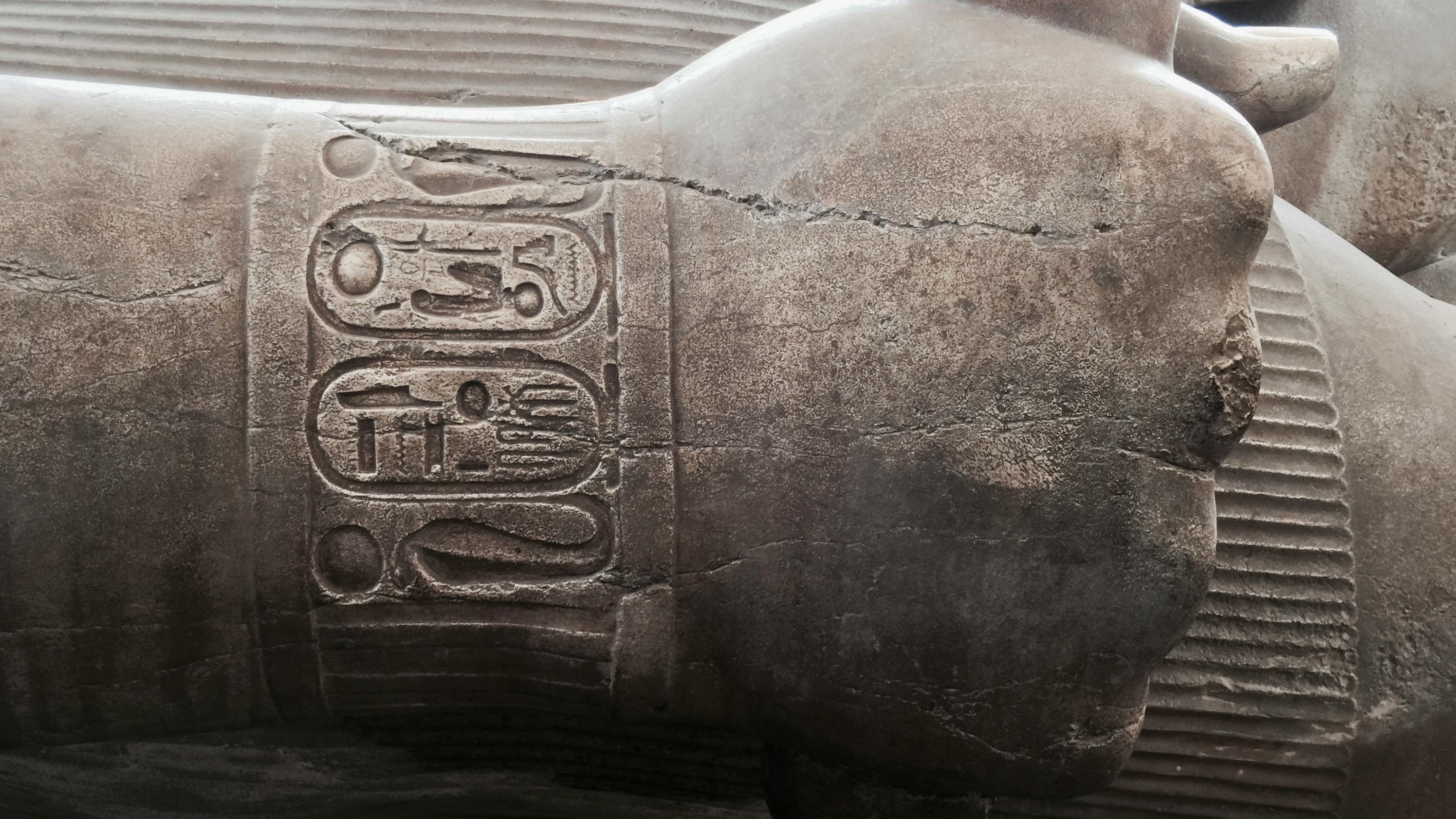 ancient Egyptian statue with fist clenched