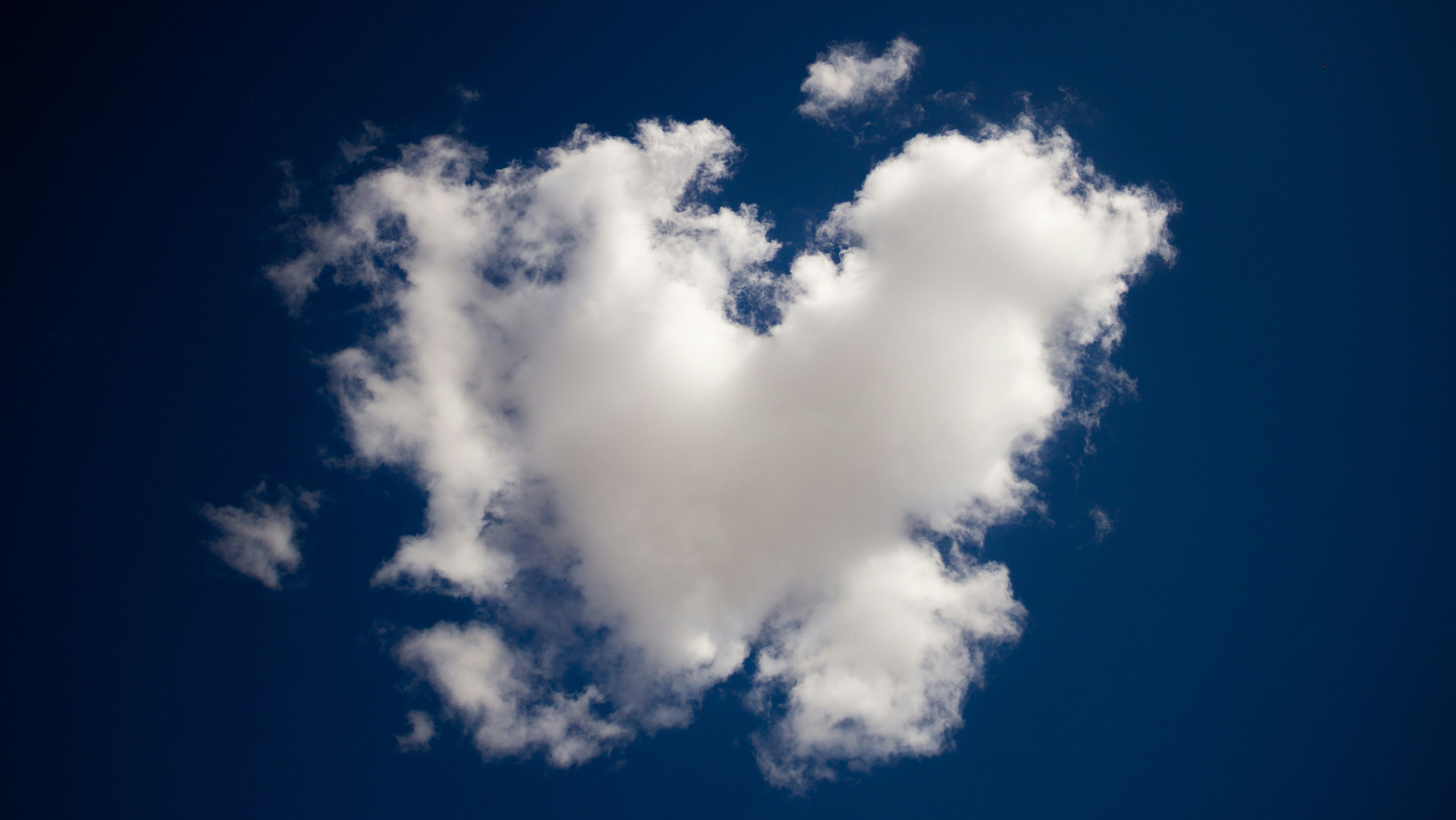 heart-shaped cloud in blue sky