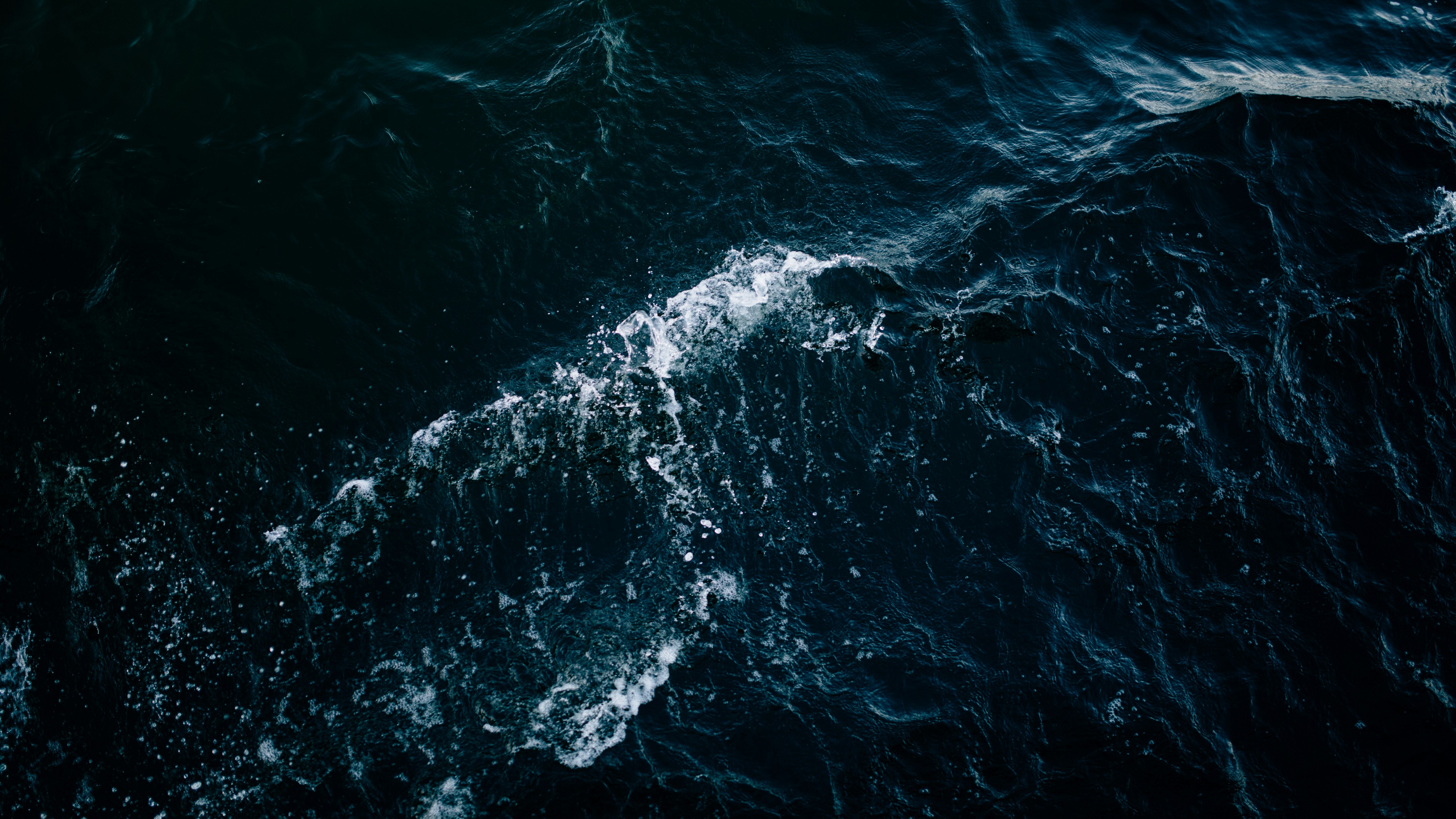 dark churning ocean with white foam