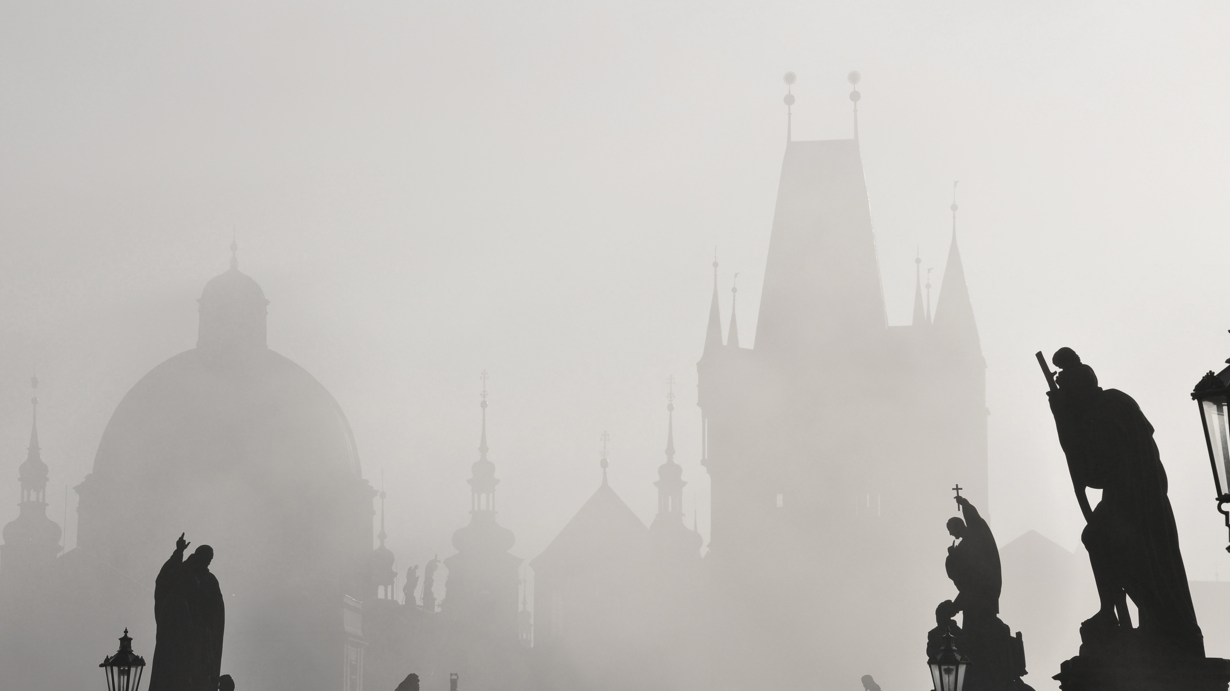 silhouettes of buildings and statues in prague