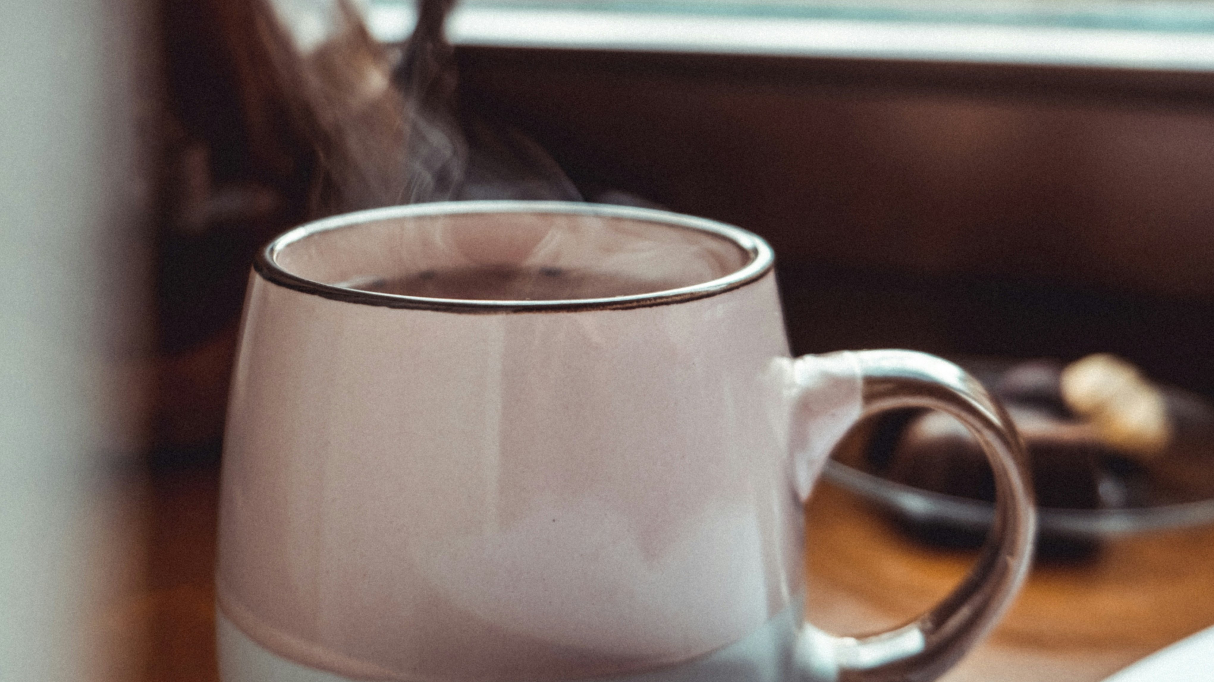 coffee cup on desk by window