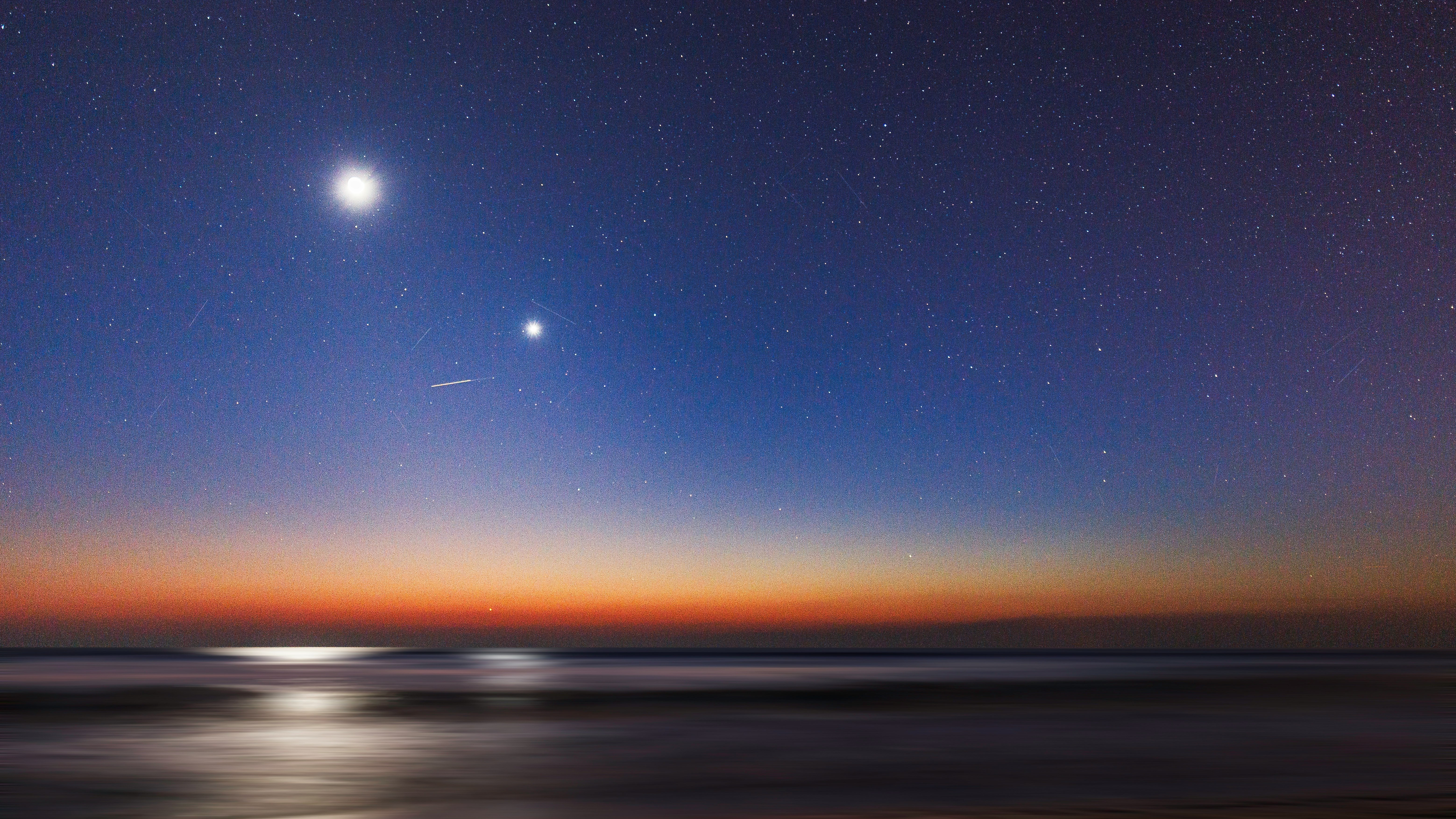 two stars above a beach at sunset