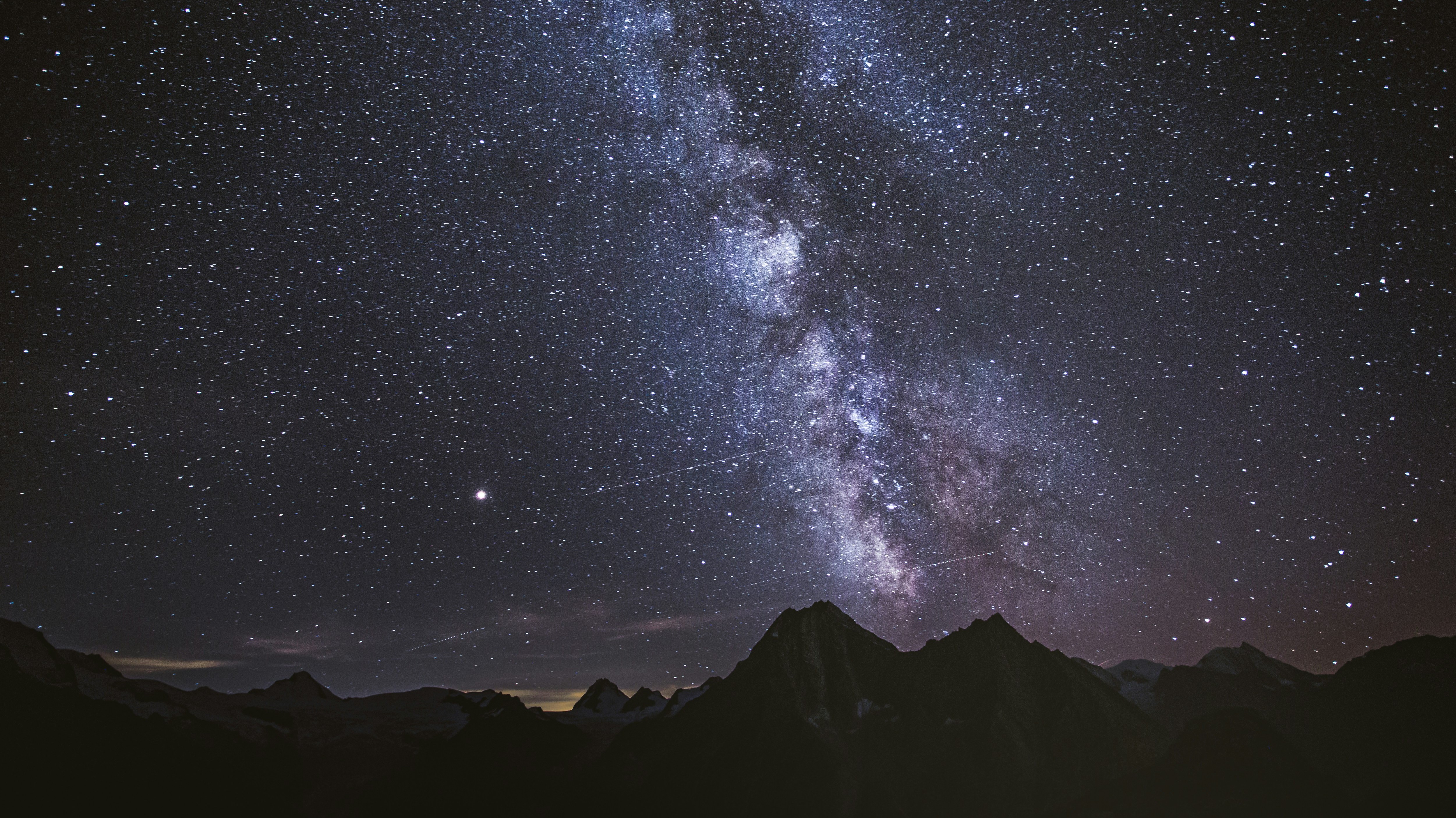 milky way at night over a mountain range