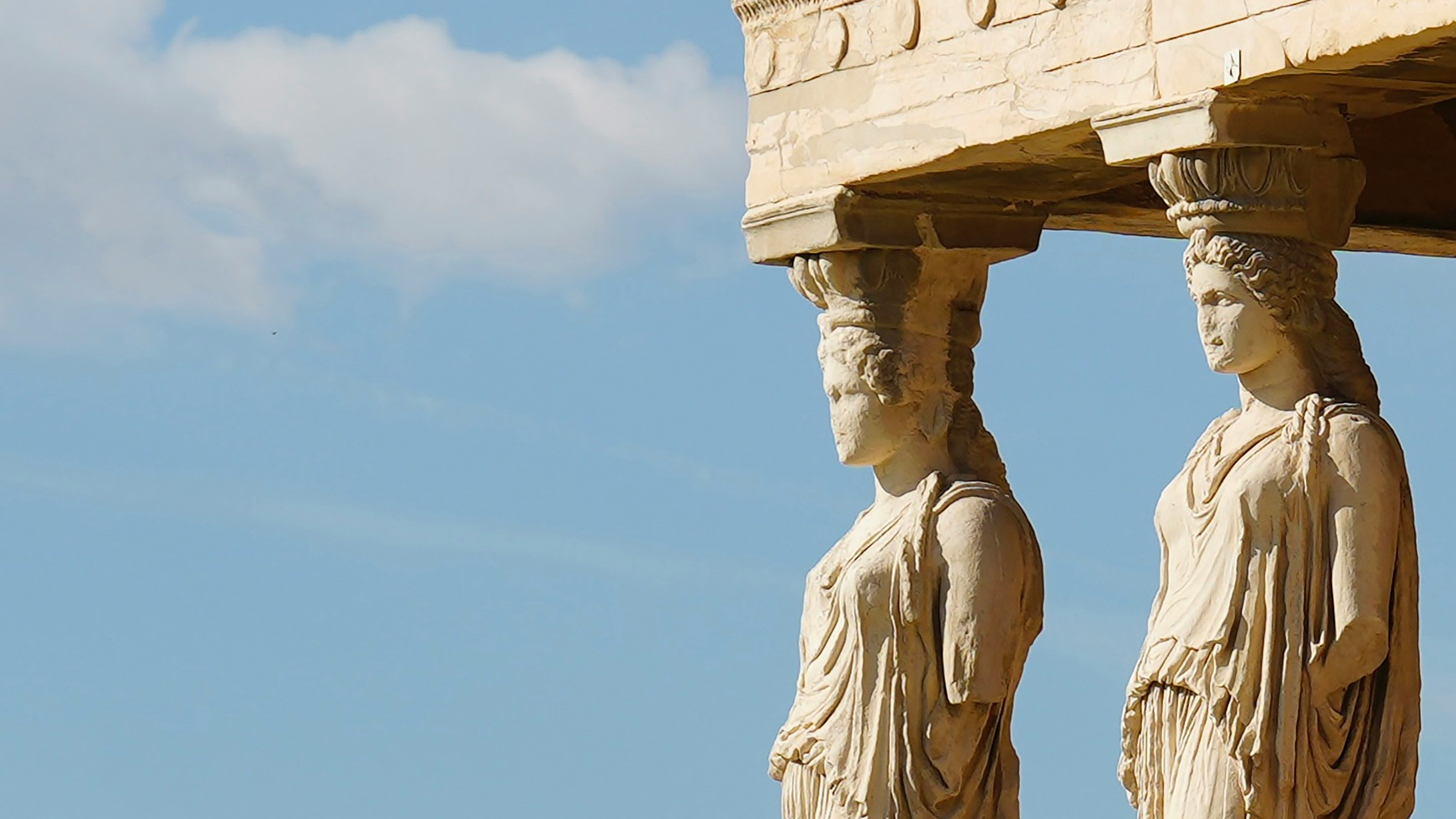 caryatids looking off pensively towards sky