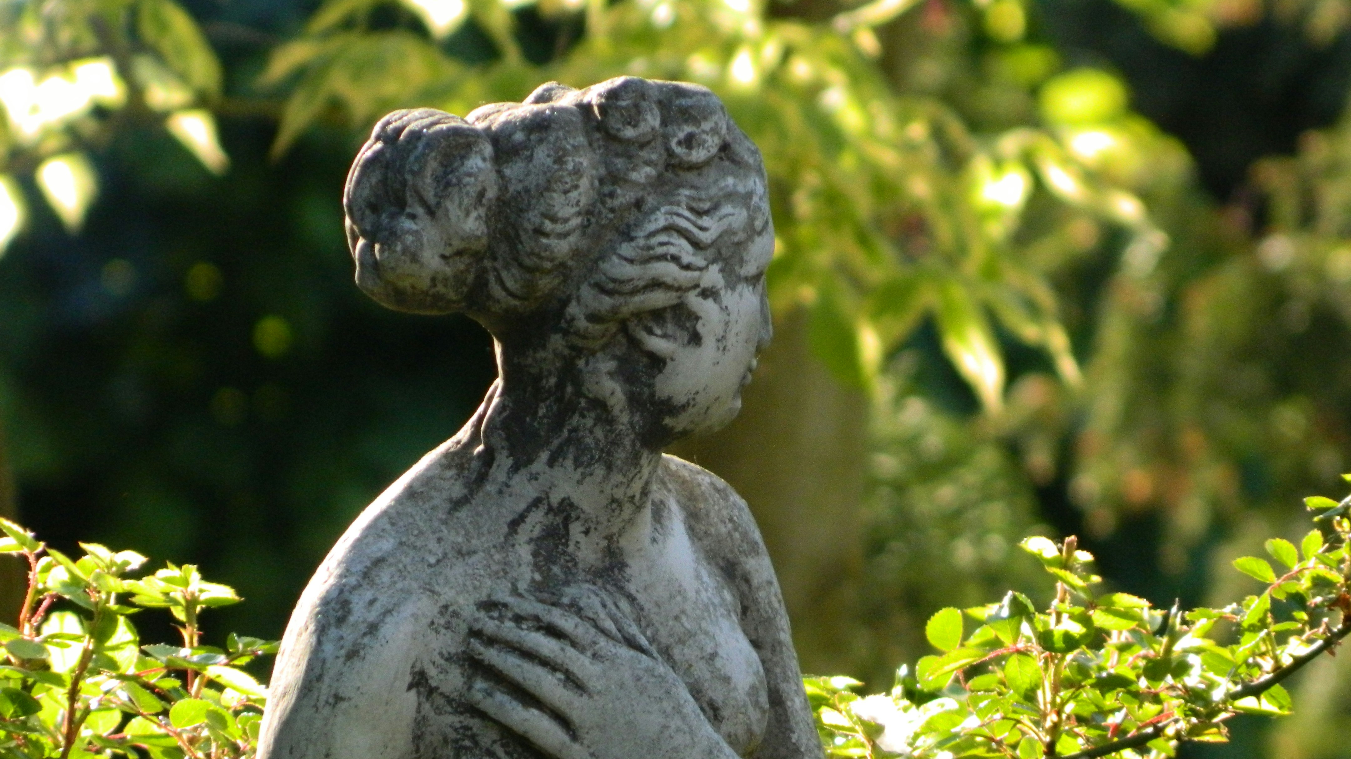 statue of woman turning away from viewer