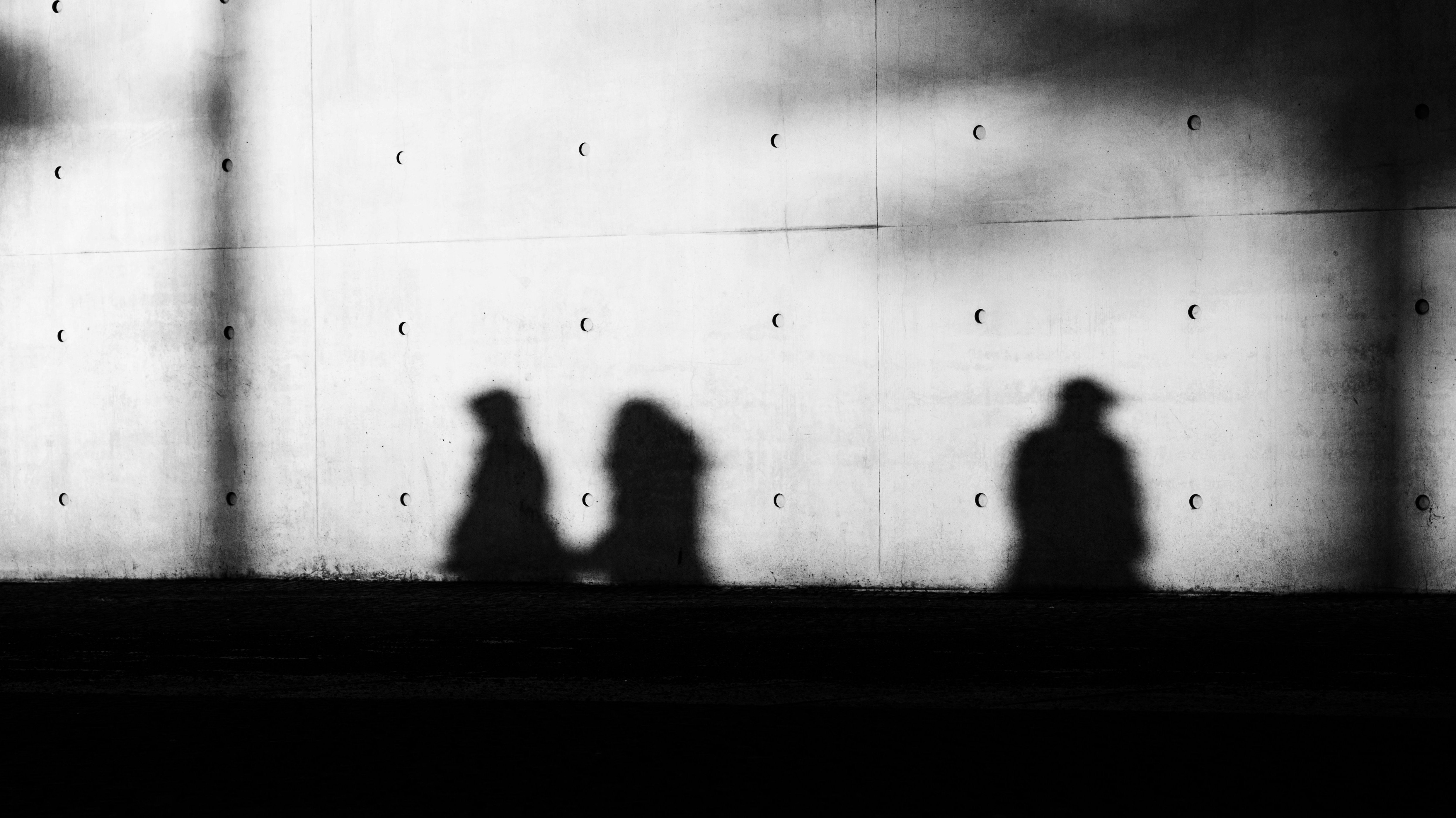 people's shadows standing next to each other